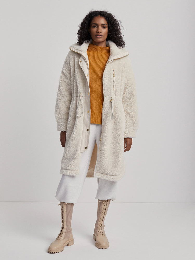 Off-white long sherpa-style coat with gold zippers. Features drawstring waist.