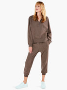 Heather brown ribbed sweatpant with relaxed fit, cuffed ankles, and side pockets, on model.