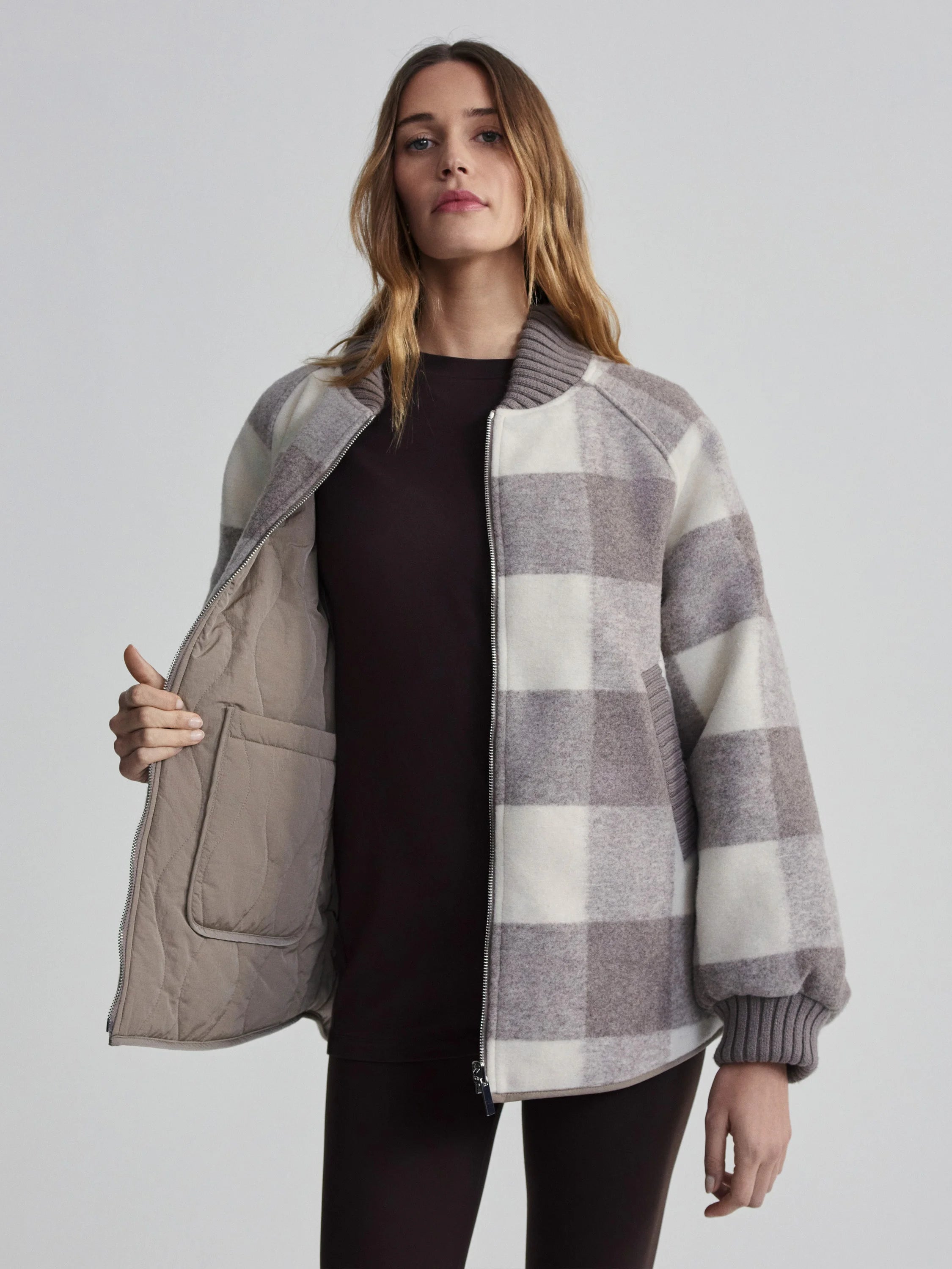 Reversible bomber jacket: cream & taupe plaid on one side, solid taupe quilted on the other. Ribbed trim.