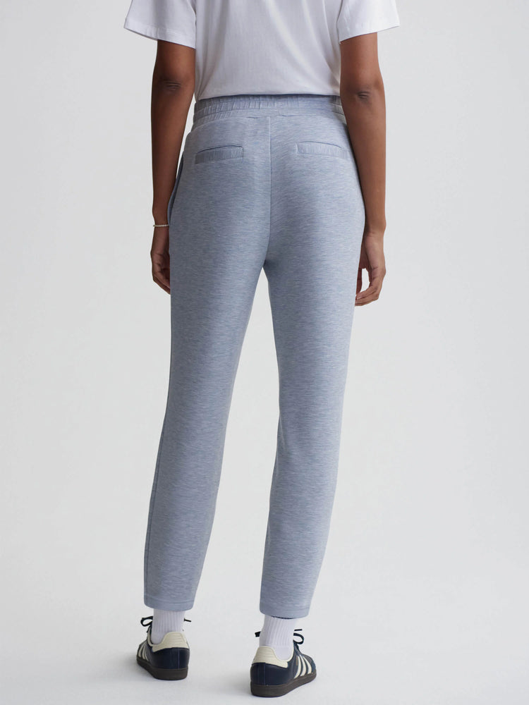 Here's alt text under 125 characters:
"Light blue heather knit slim-fit pants, seen from the back. Elastic waistband,...