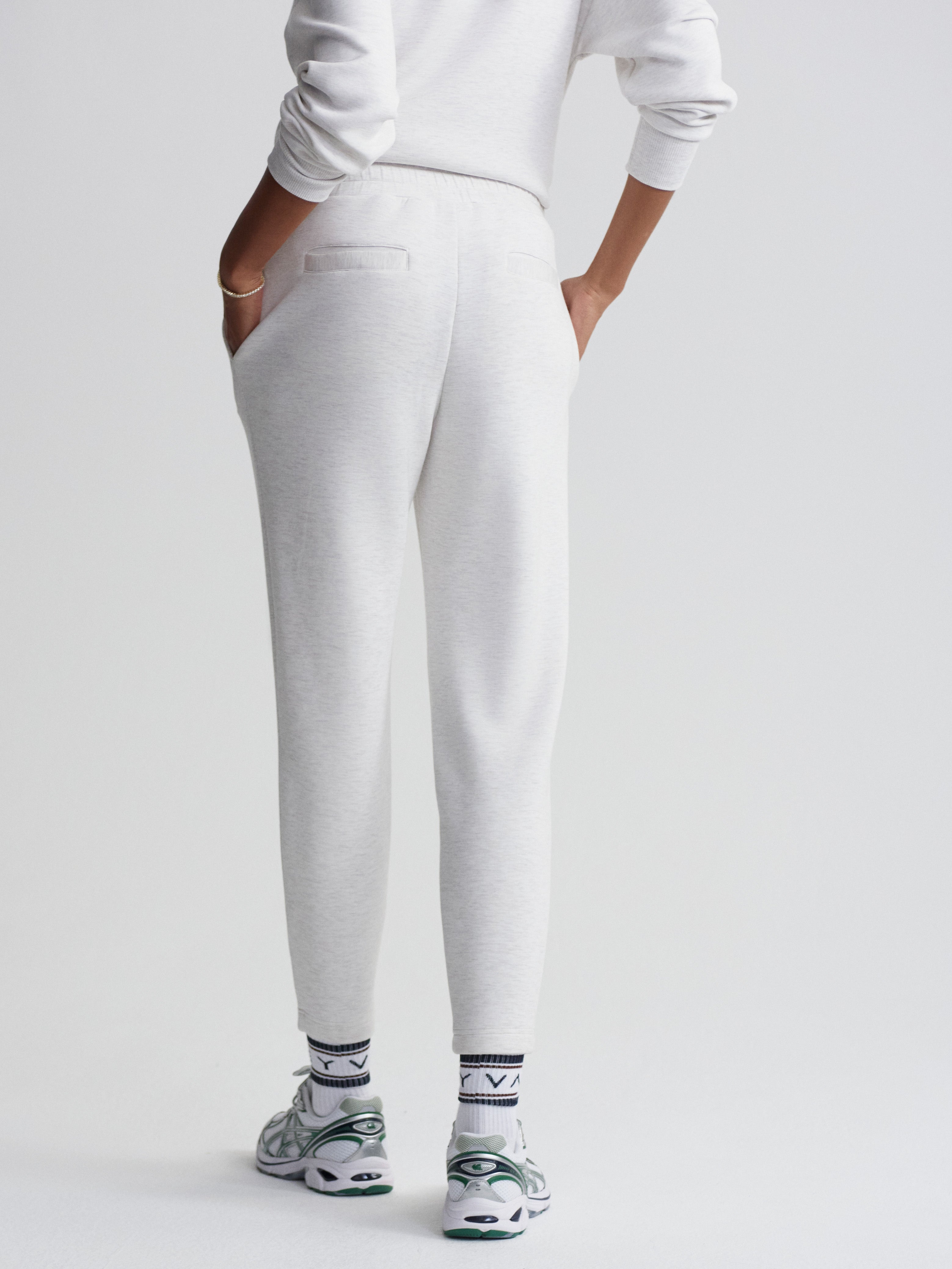 Comfortable light gray tapered sweatpants with rear welt pockets and an elastic waist detail.
