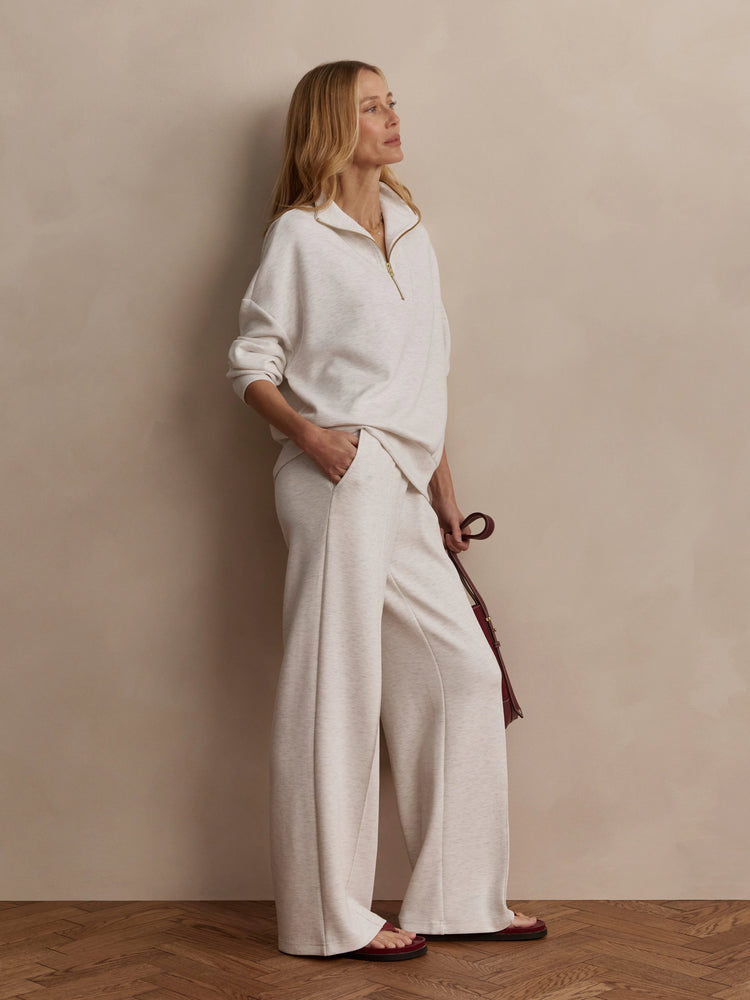 Light heather gray wide-leg pants in a soft knit fabric. Worn by a model to show the full length.