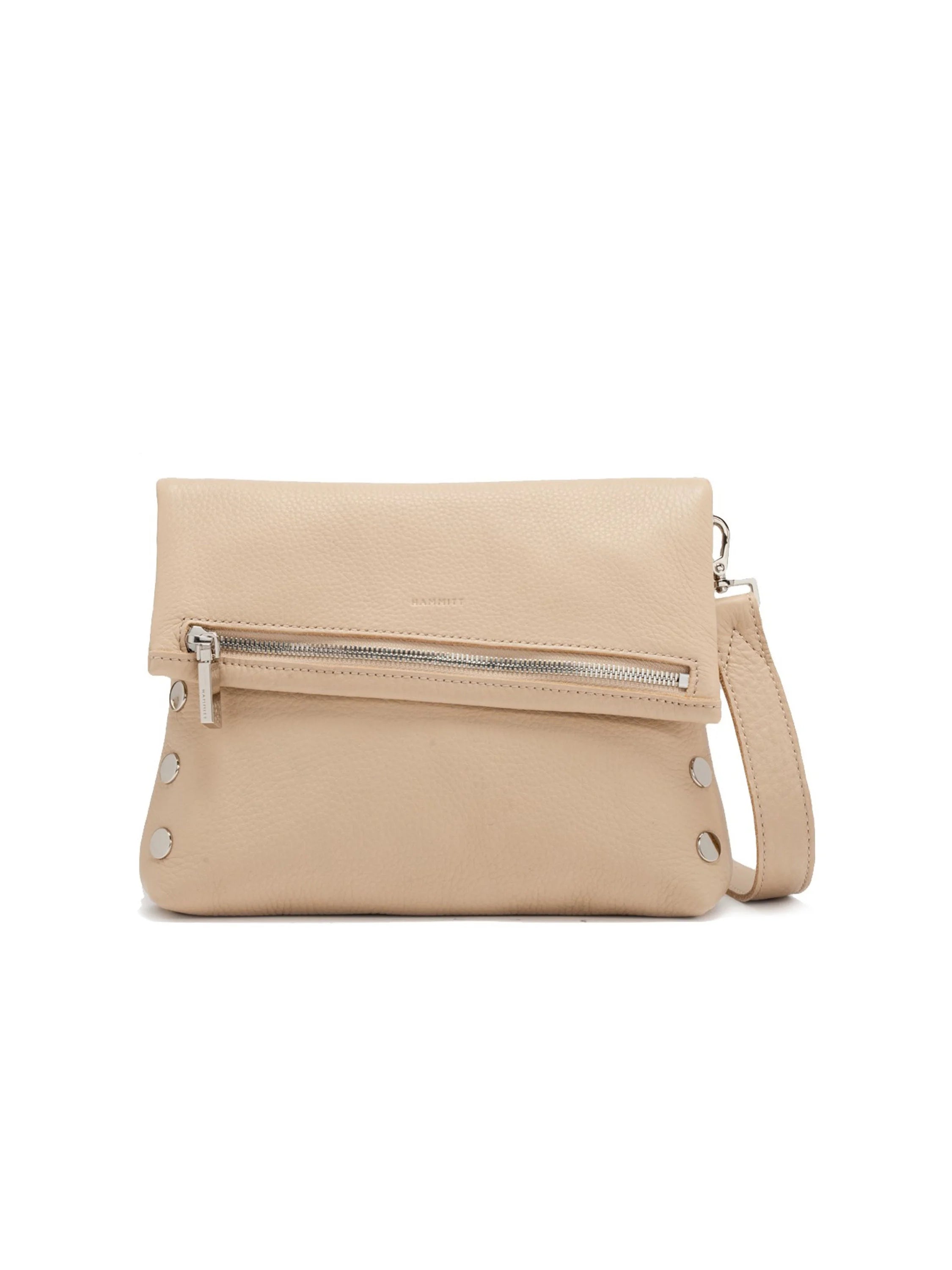 Light beige pebbled leather fold-over handbag with a diagonal silver zipper, front silver stud details, and a strap.