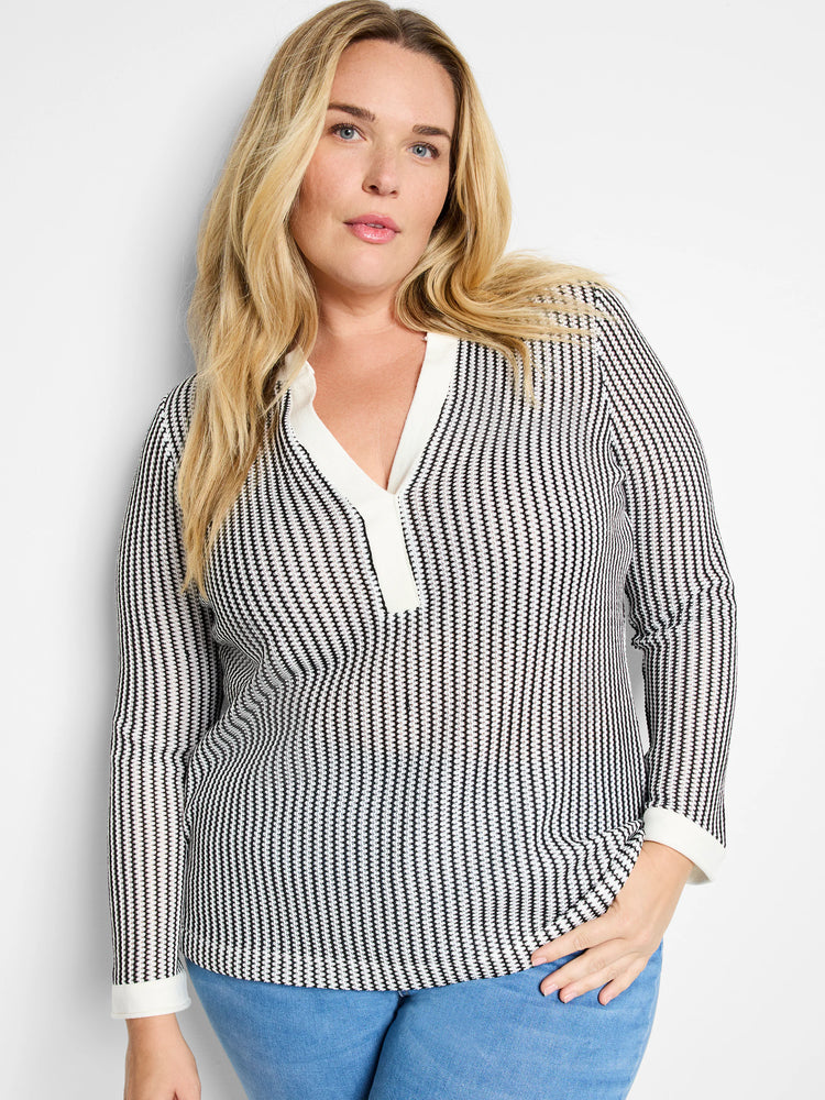 Black and white vertically striped long-sleeve top. Split neckline with off-white trim.