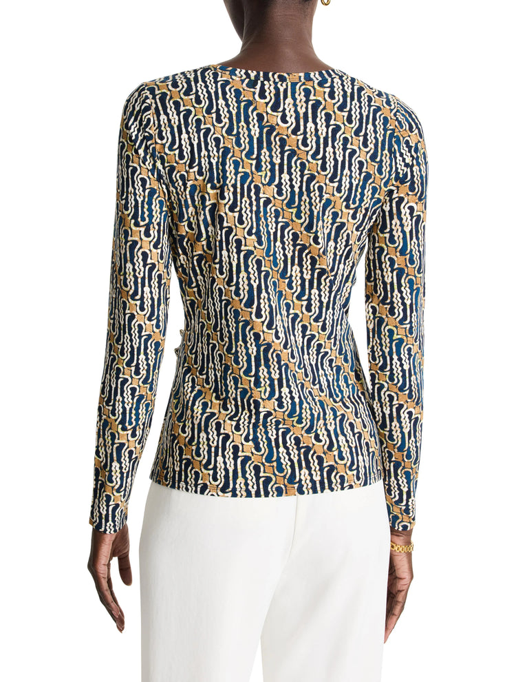 Long-sleeved top, navy, beige, and white abstract batik pattern. Close-fitting.