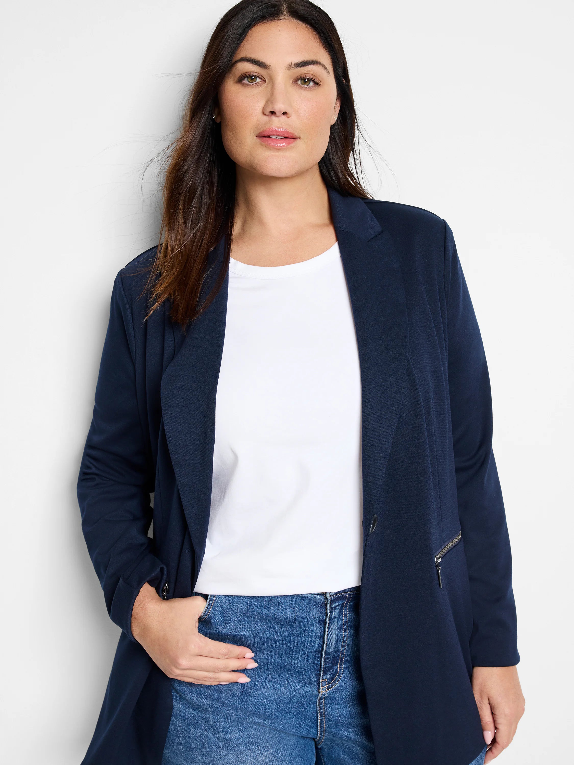 Navy blue zip-front jacket; single button. Features a side zip pocket.