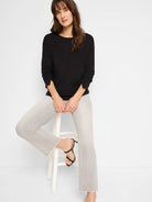 Black sparkly long-sleeve top,  round neck.