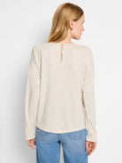 Beige sparkly long-sleeve top, keyhole back detail.