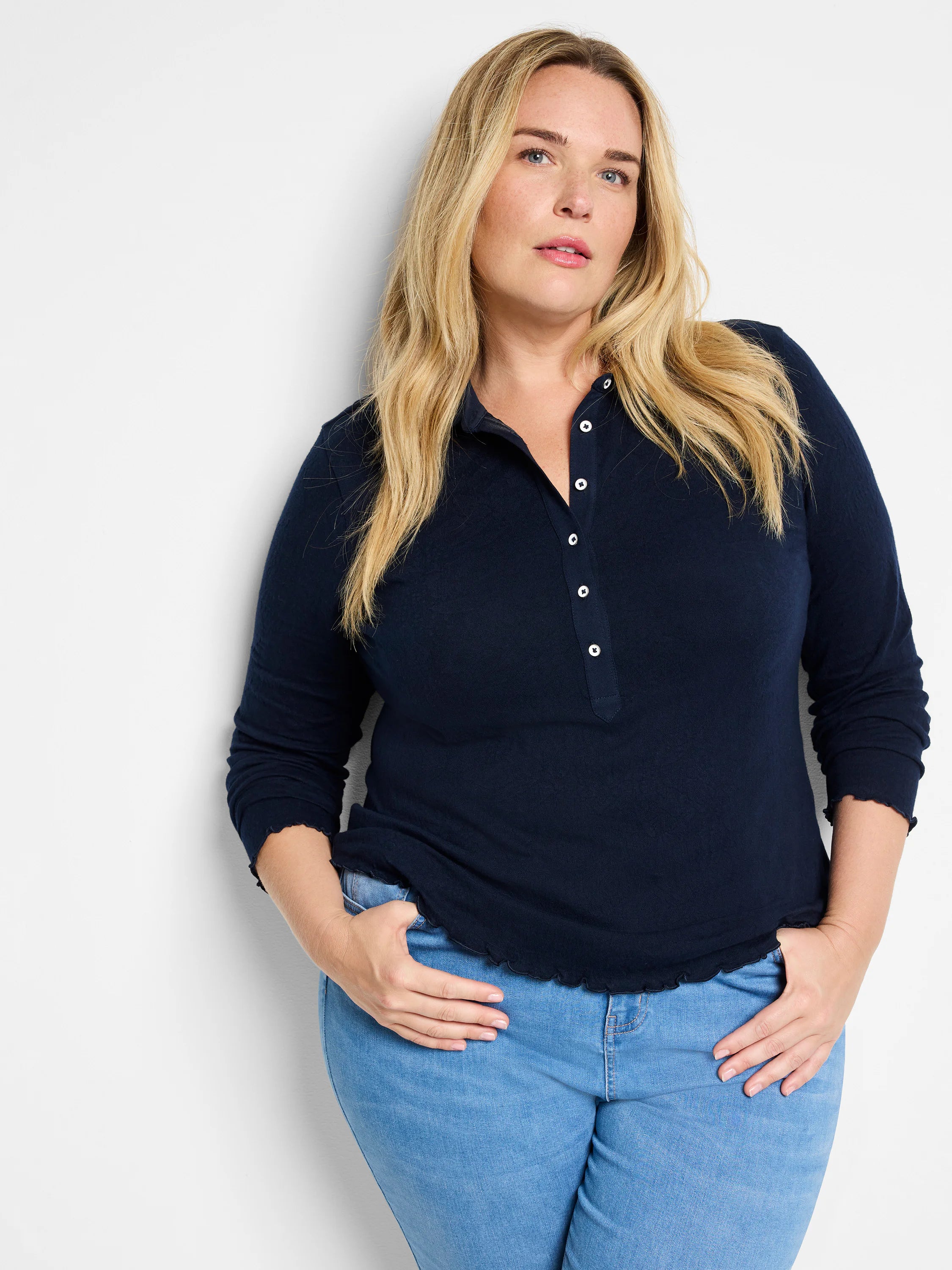 Navy lace knit collared top with white buttons, long sleeves, and ruffled edges.