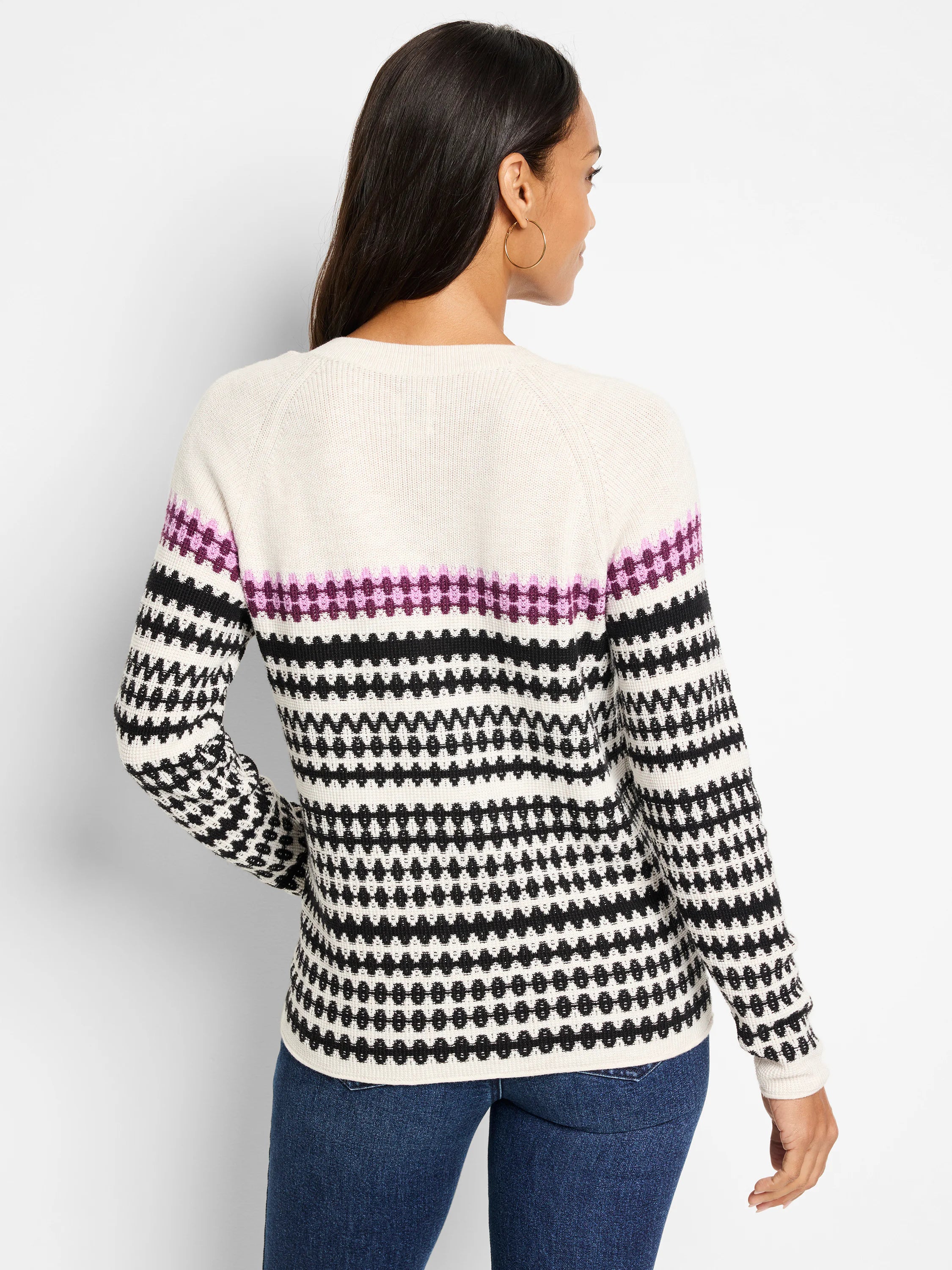 Cream V-neck sweater with black and purple horizontal patterned stripes. Long sleeves.