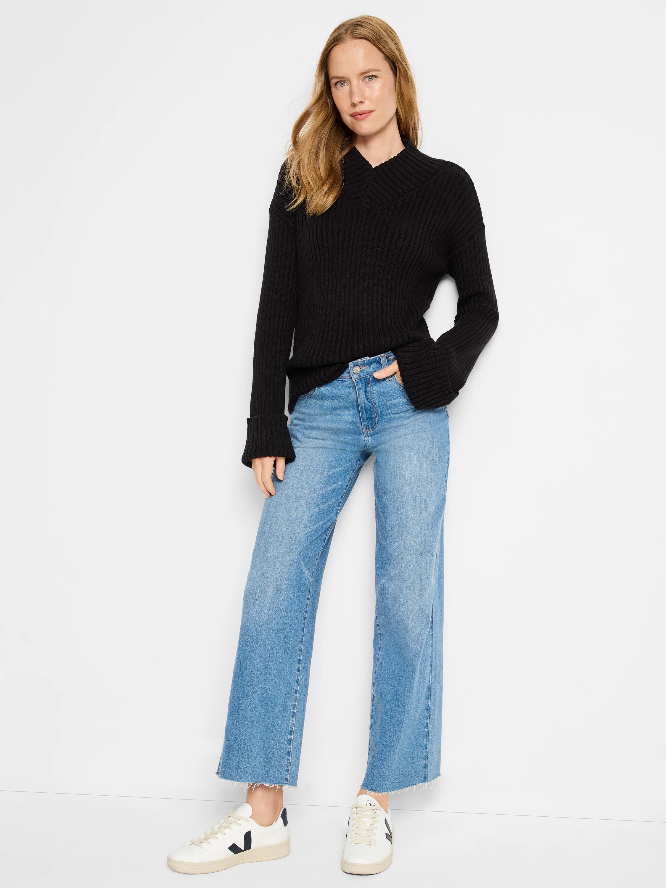 Black ribbed V-neck sweater; long sleeves with cuffed ends.