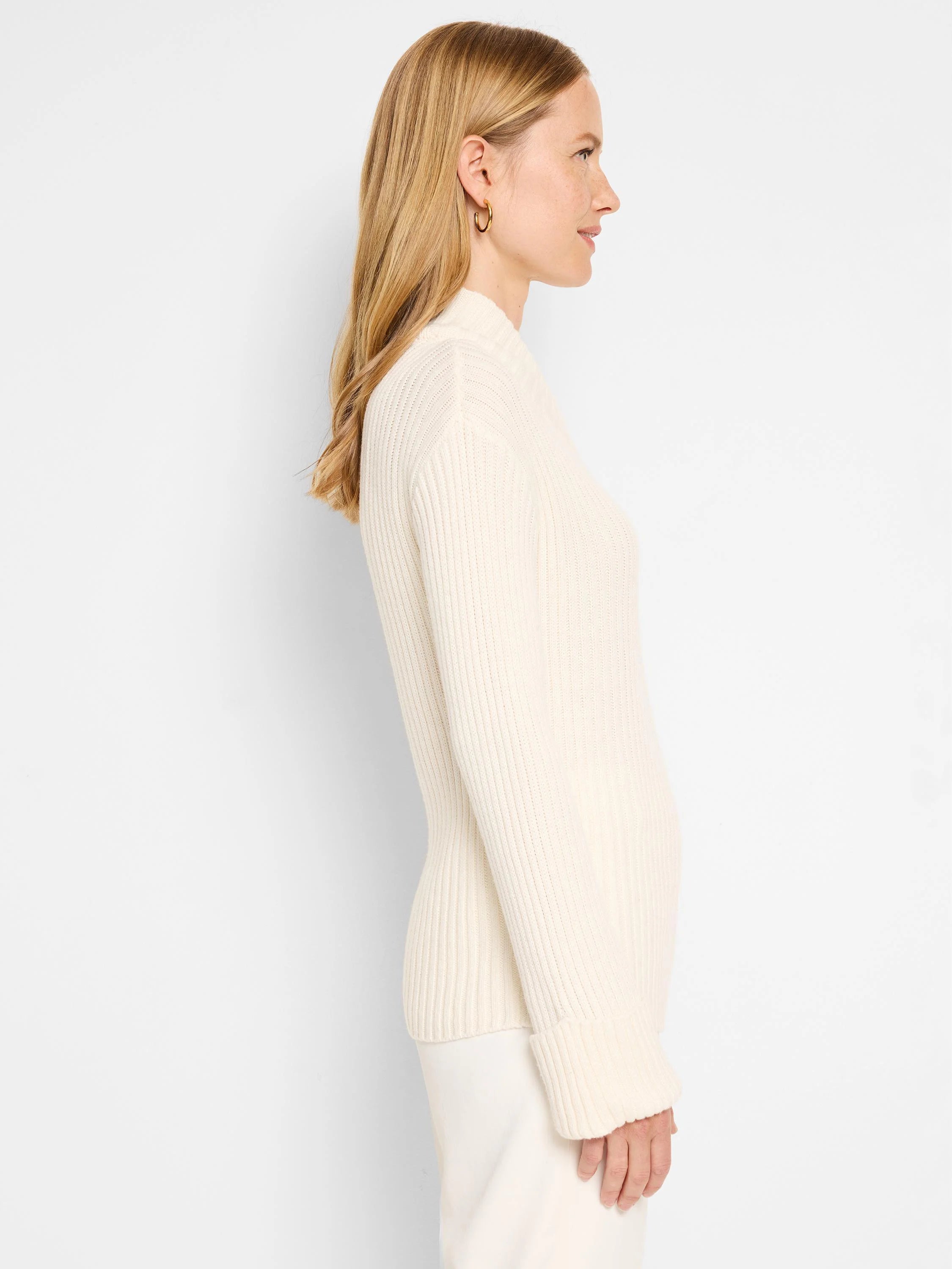 Off-white ribbed mock neck sweater. Long sleeves with ribbed cuffs. Fitted silhouette.