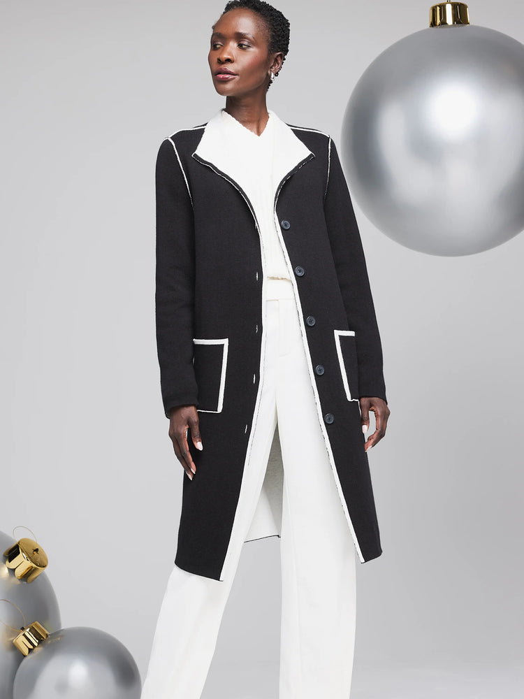 Black long cardigan with white contrast stitching, button front, and pockets. Reversible.
