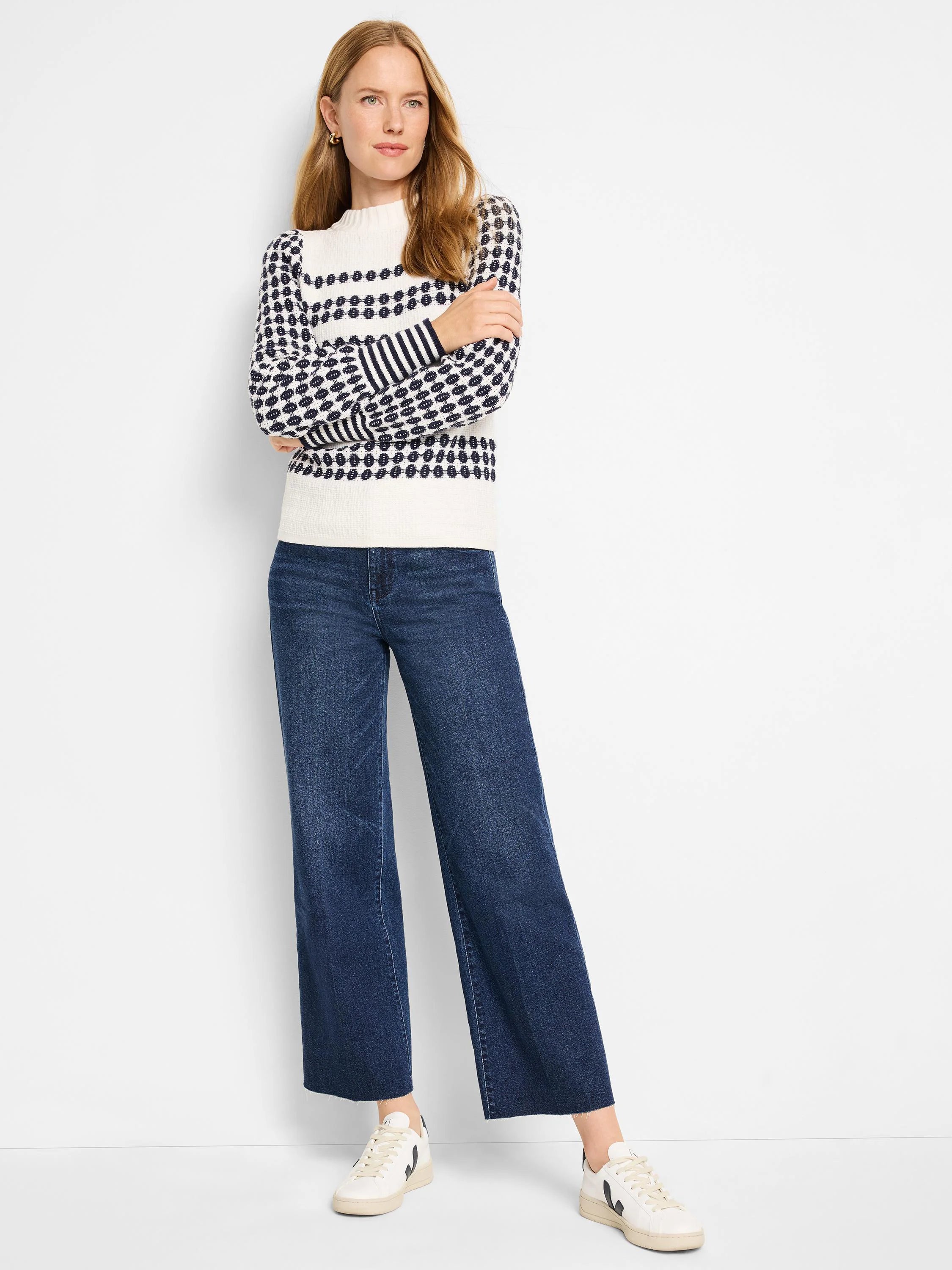 Cream waffle-knit sweater with navy horizontal stripes and pattern. Long sleeves.