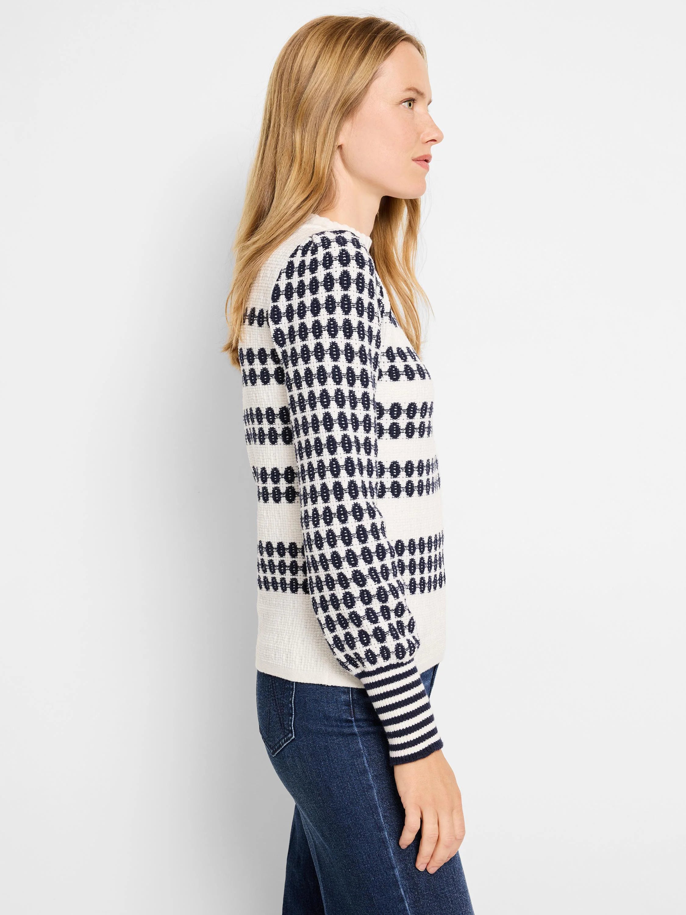 Cream waffle-knit sweater with navy horizontal stripes and pattern. Navy stripes on cuffs.