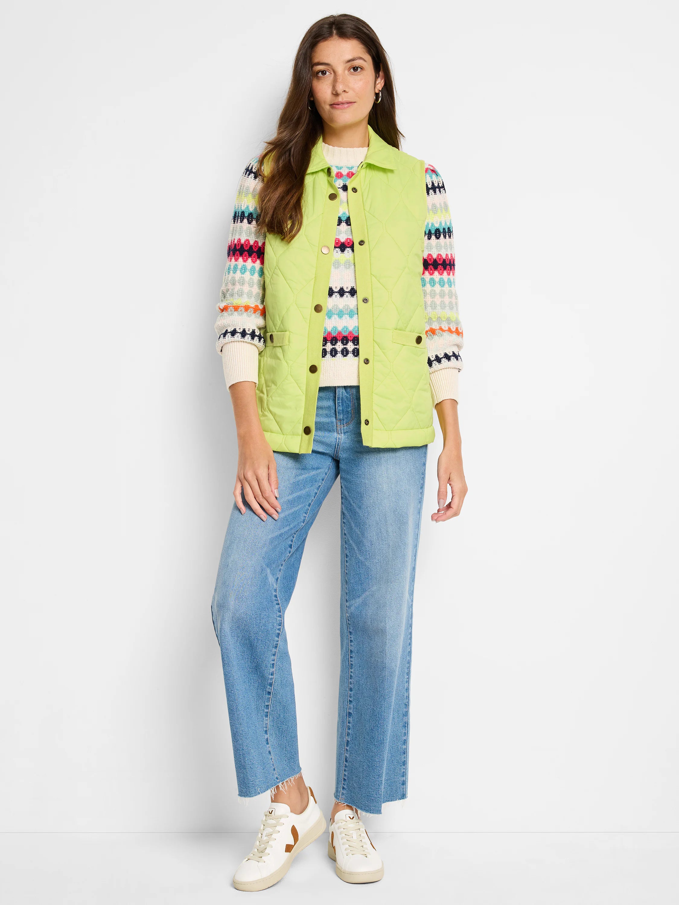 Lime green quilted vest with gold buttons. Features diamond pattern quilting. Model also wears multicolored striped...