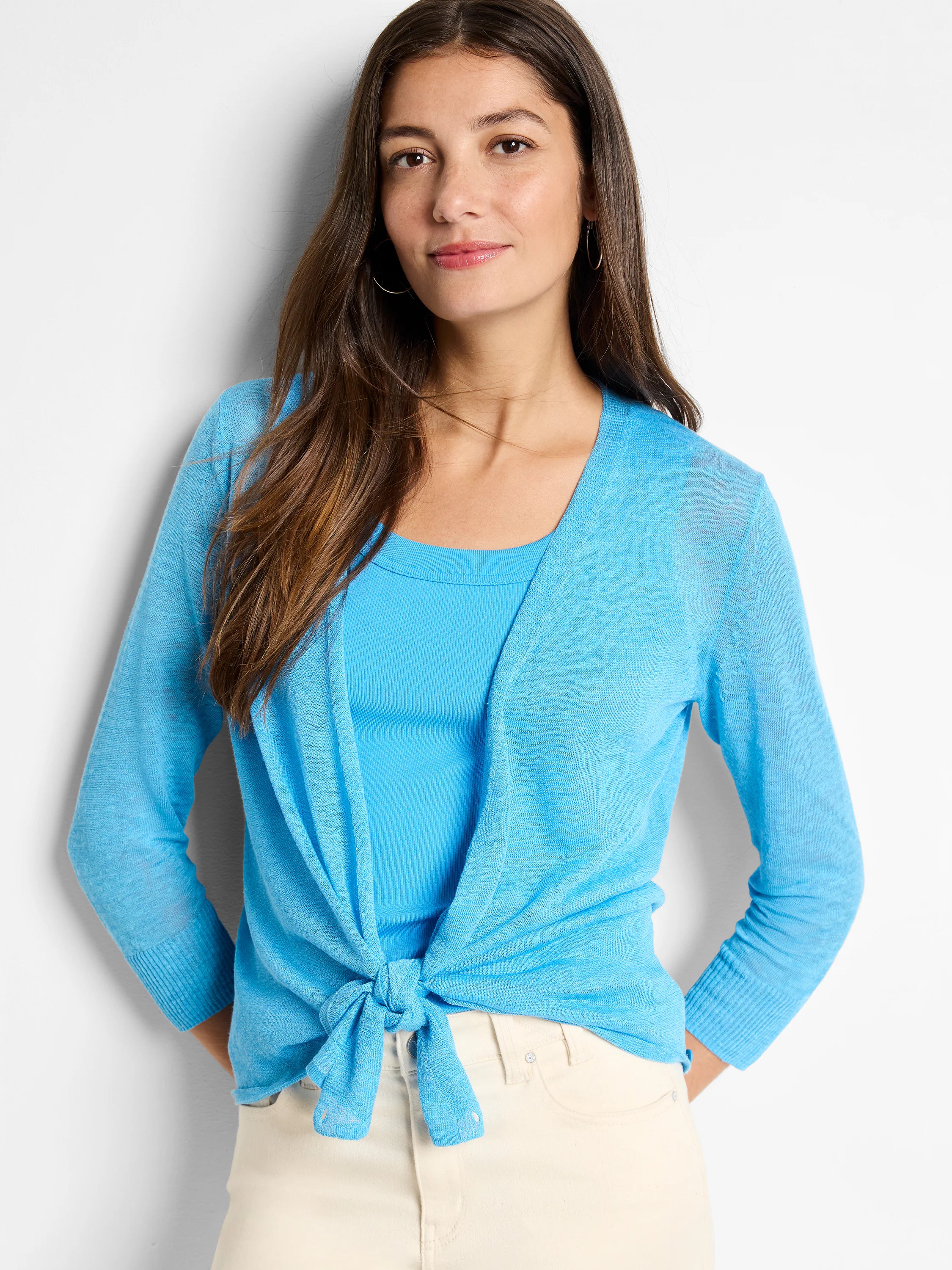 Bright blue sheer knit cardigan with long sleeves and ribbed cuffs, styled tied at the front.