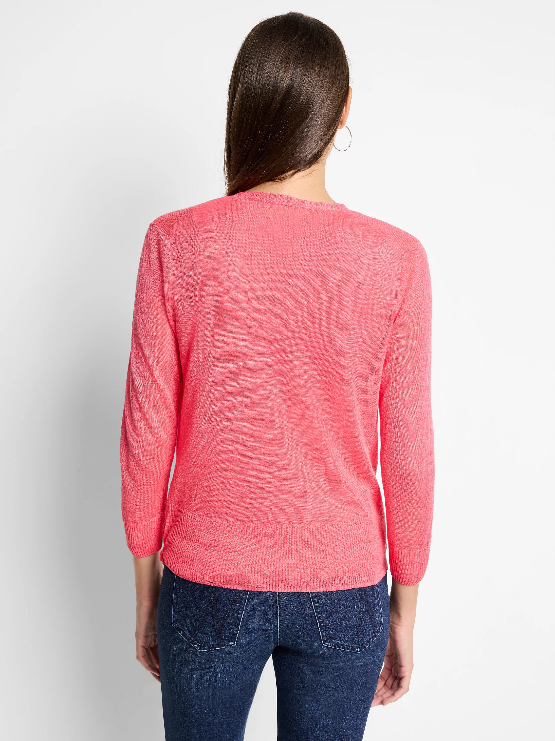 Vibrant pink lightweight knit cardigan with 3/4 sleeves and ribbed hem, viewed from back on model.
