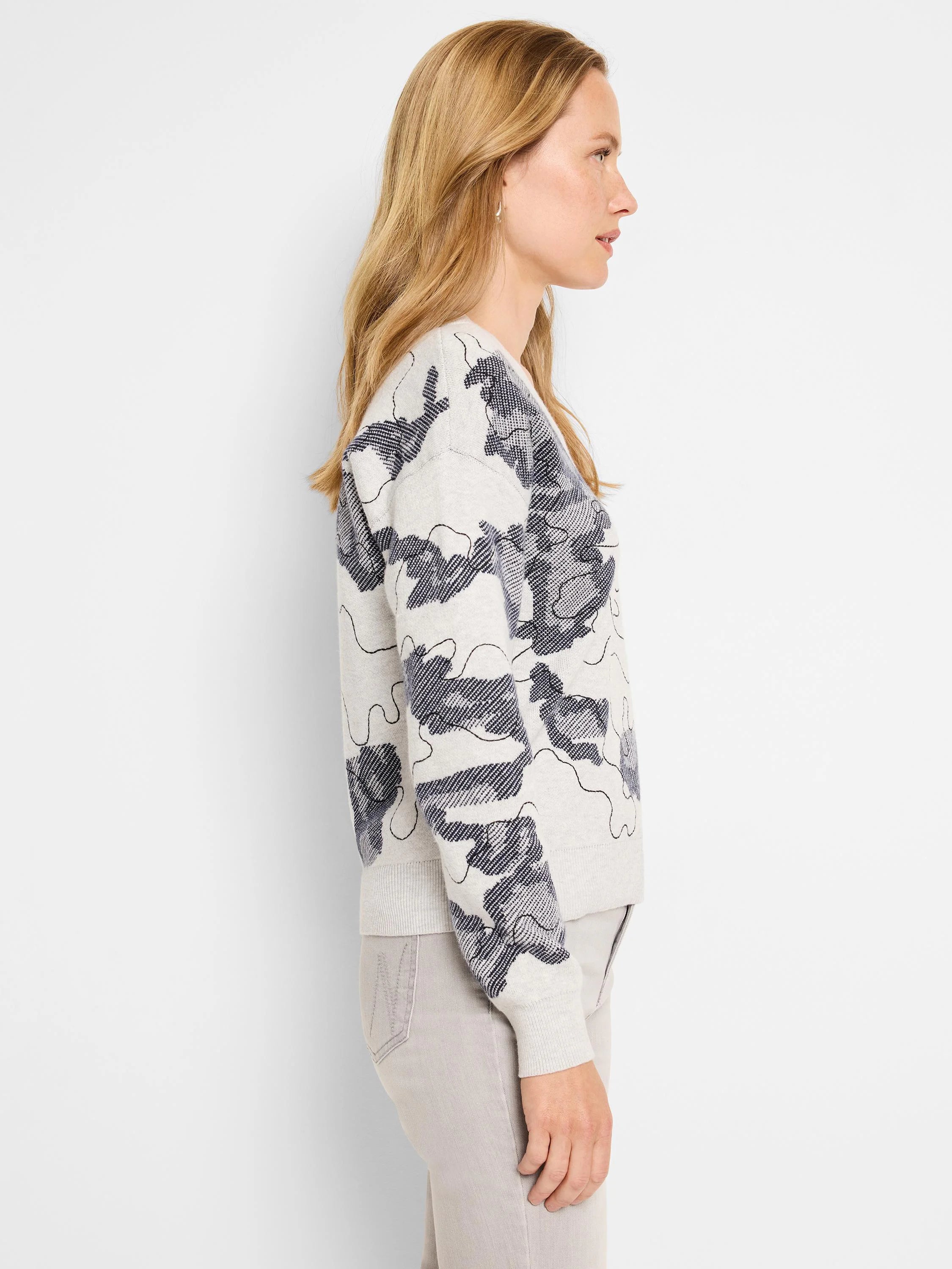Off-white sweater with dark gray abstract pattern. Long sleeves, cropped length.