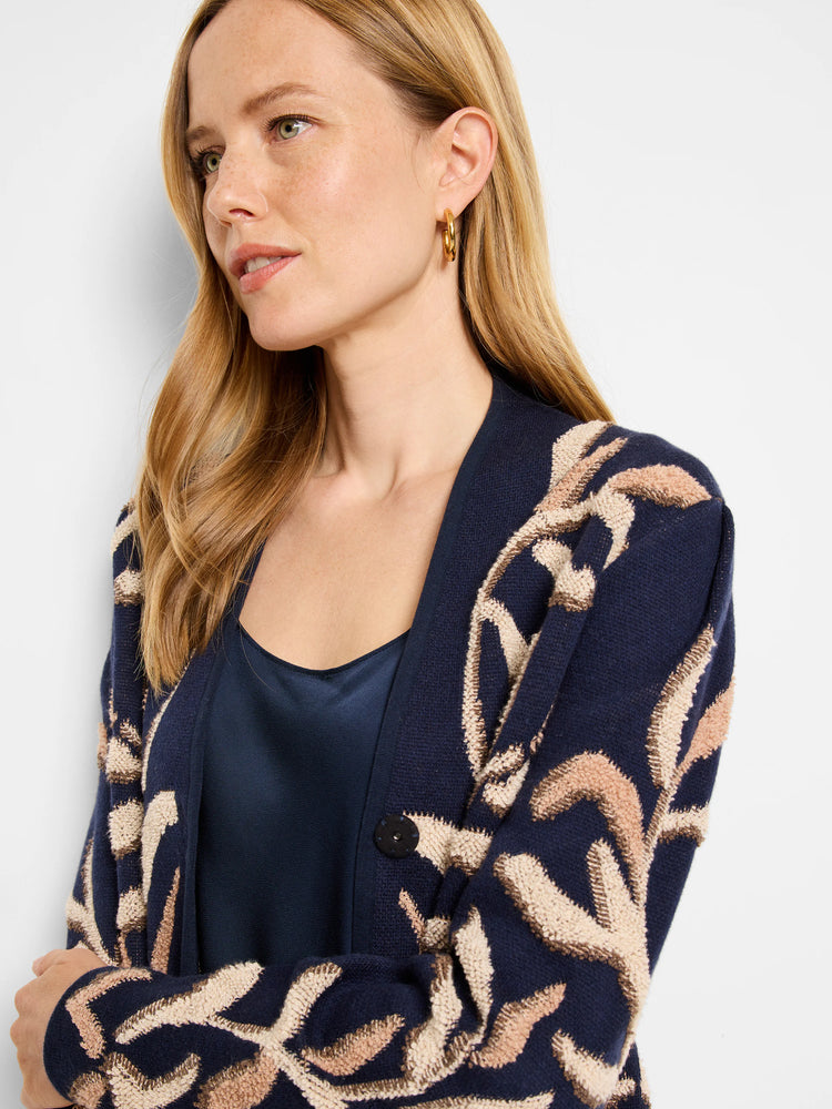 Navy blue knit cardigan with a tufted, beige and brown fern pattern. Button front.