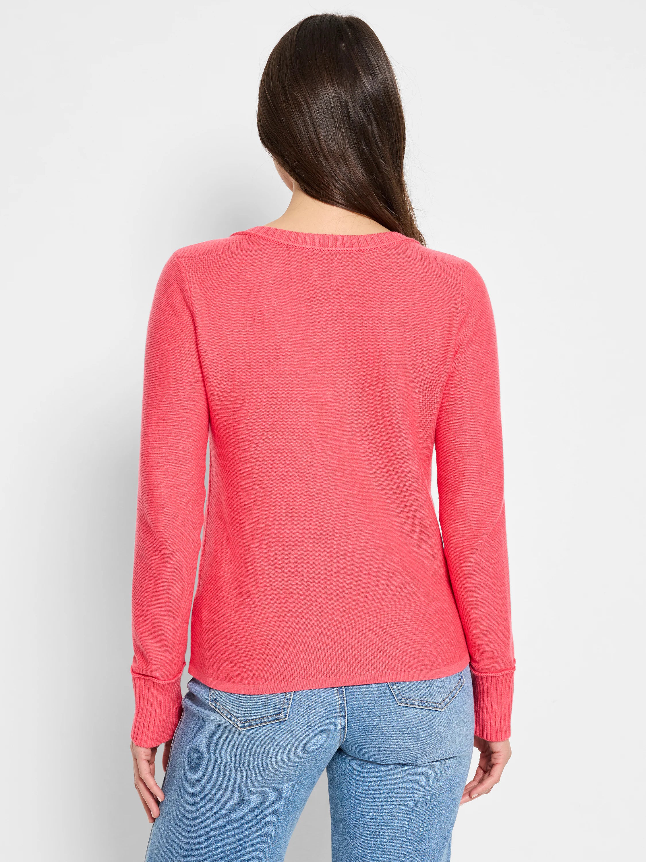Back view of a salmon pink fine knit sweater with long sleeves, ribbed crew neck collar and cuffs.
