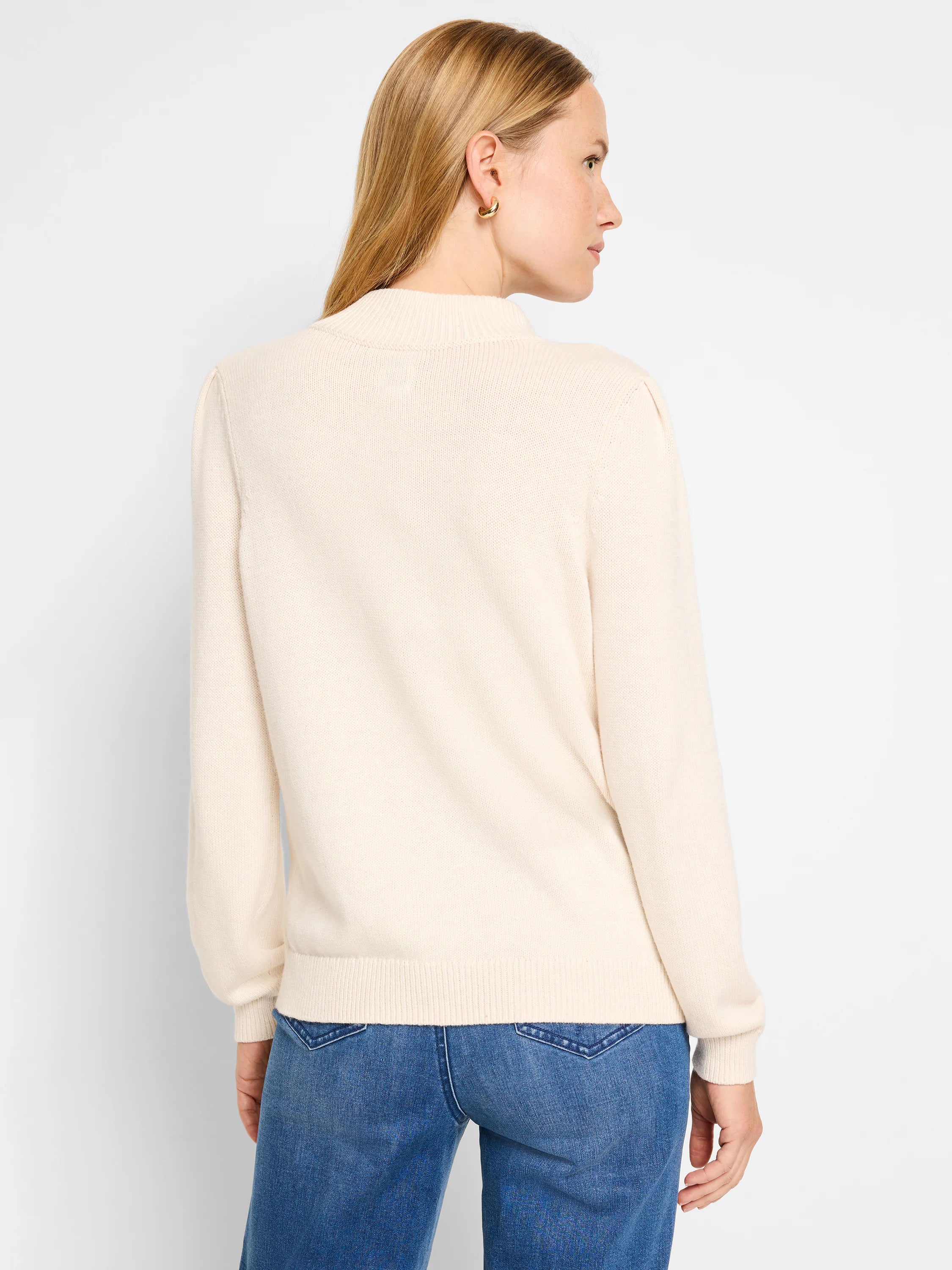 Cream-colored henley sweater, long sleeves, ribbed cuffs and hem. Shown from the back.