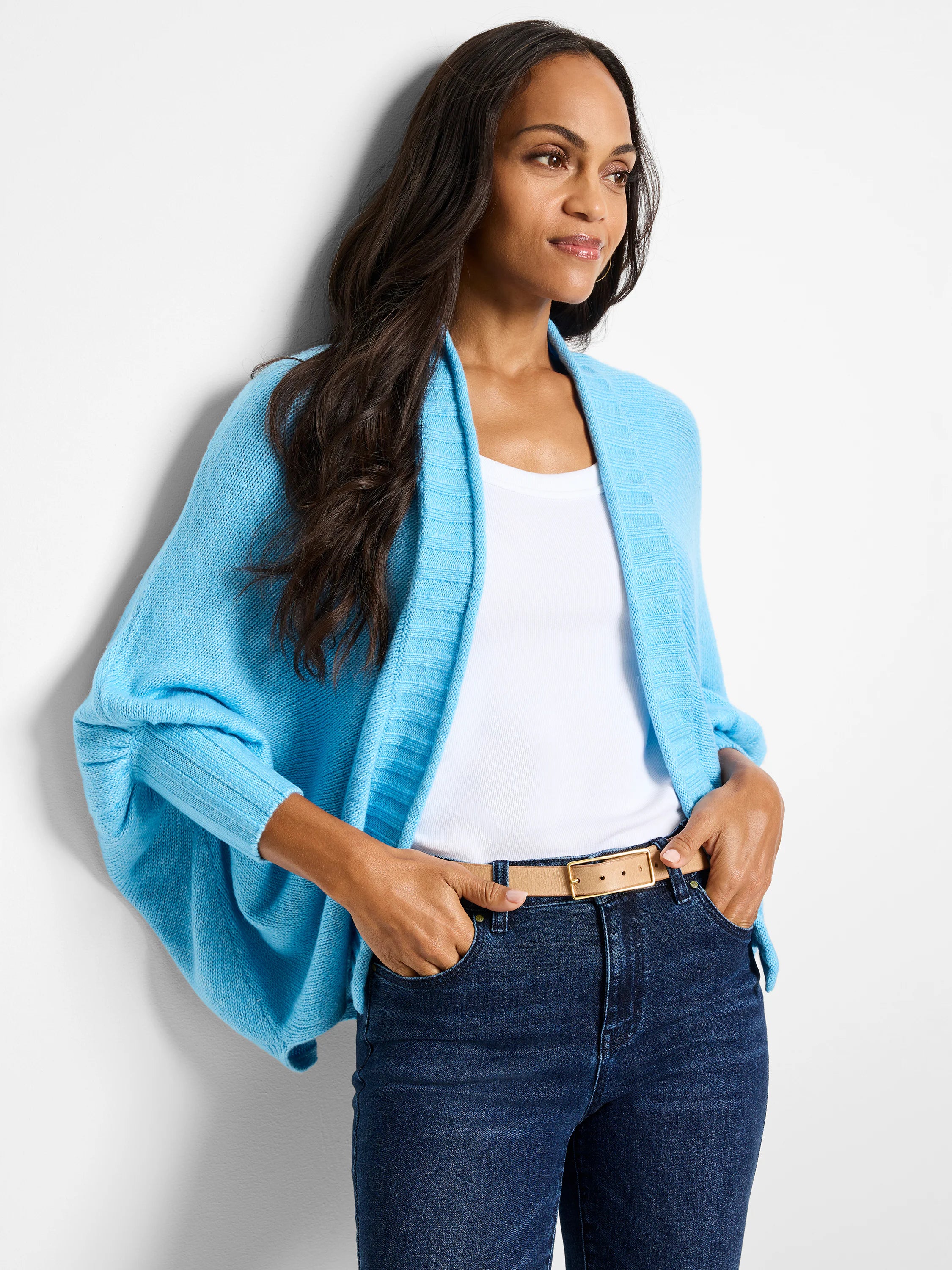 Light blue open cardigan, batwing sleeves, ribbed detail. Model wears it over a white top.
