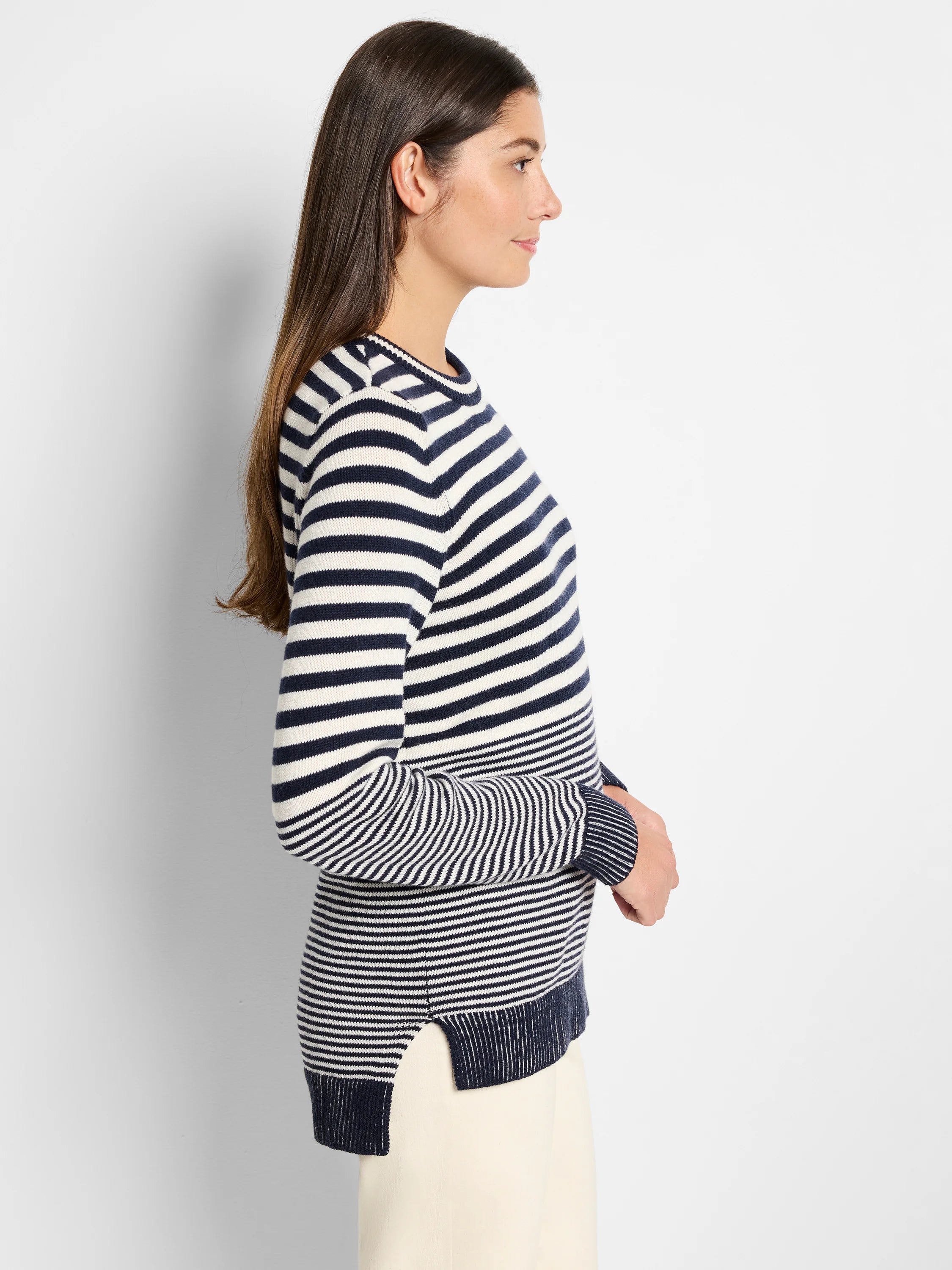 Image of cream and navy blue horizontally striped, long-sleeved cotton cashmere sweater. Side view.
