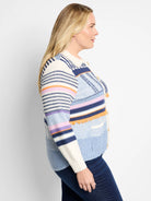Cream, blue, and purple striped cardigan.  Features embroidered details and fringe trim. Button front.