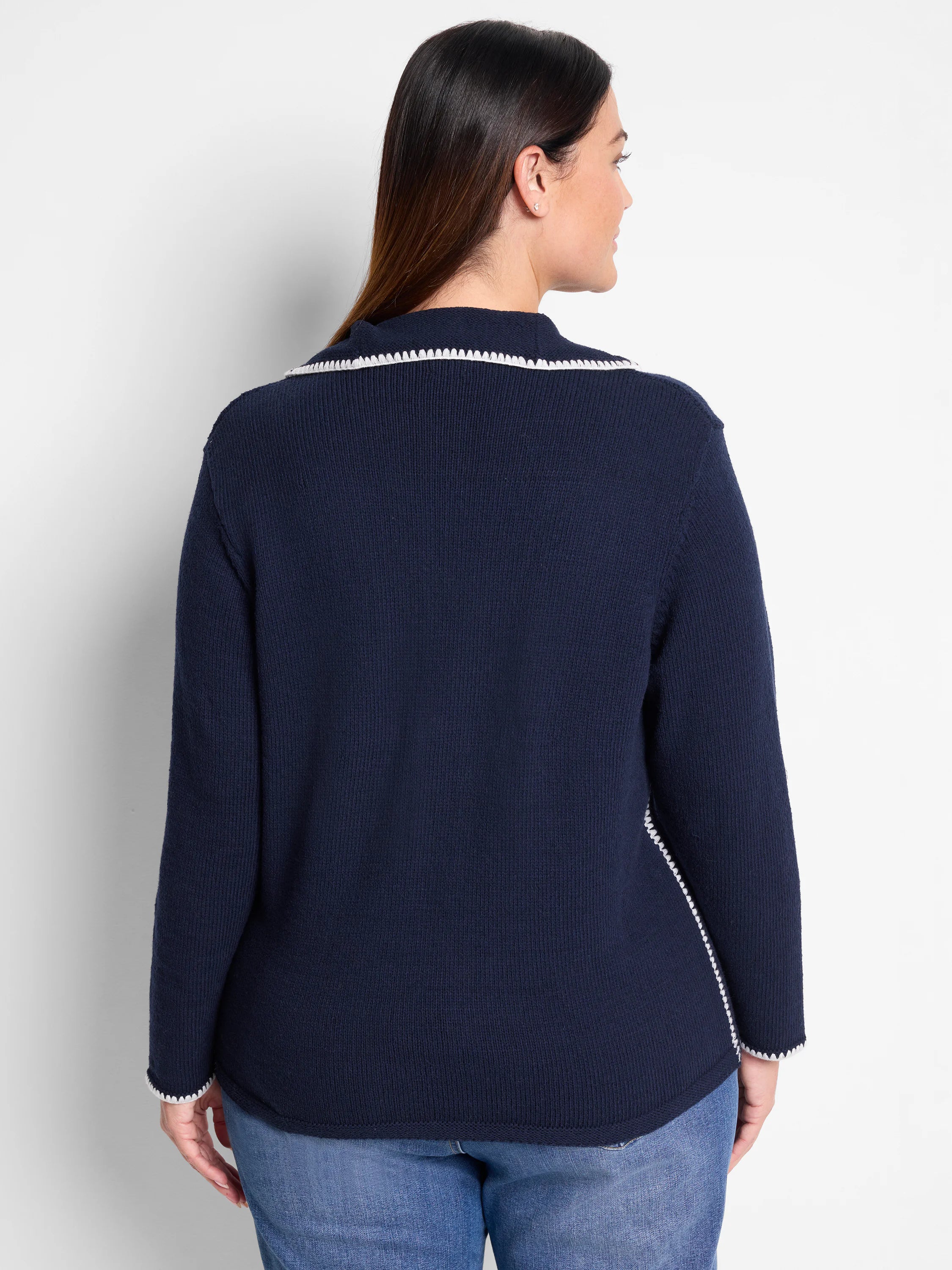 Dark navy blue sweater with off-white blanket stitch trim at neckline and sides. Ribbed knit texture.