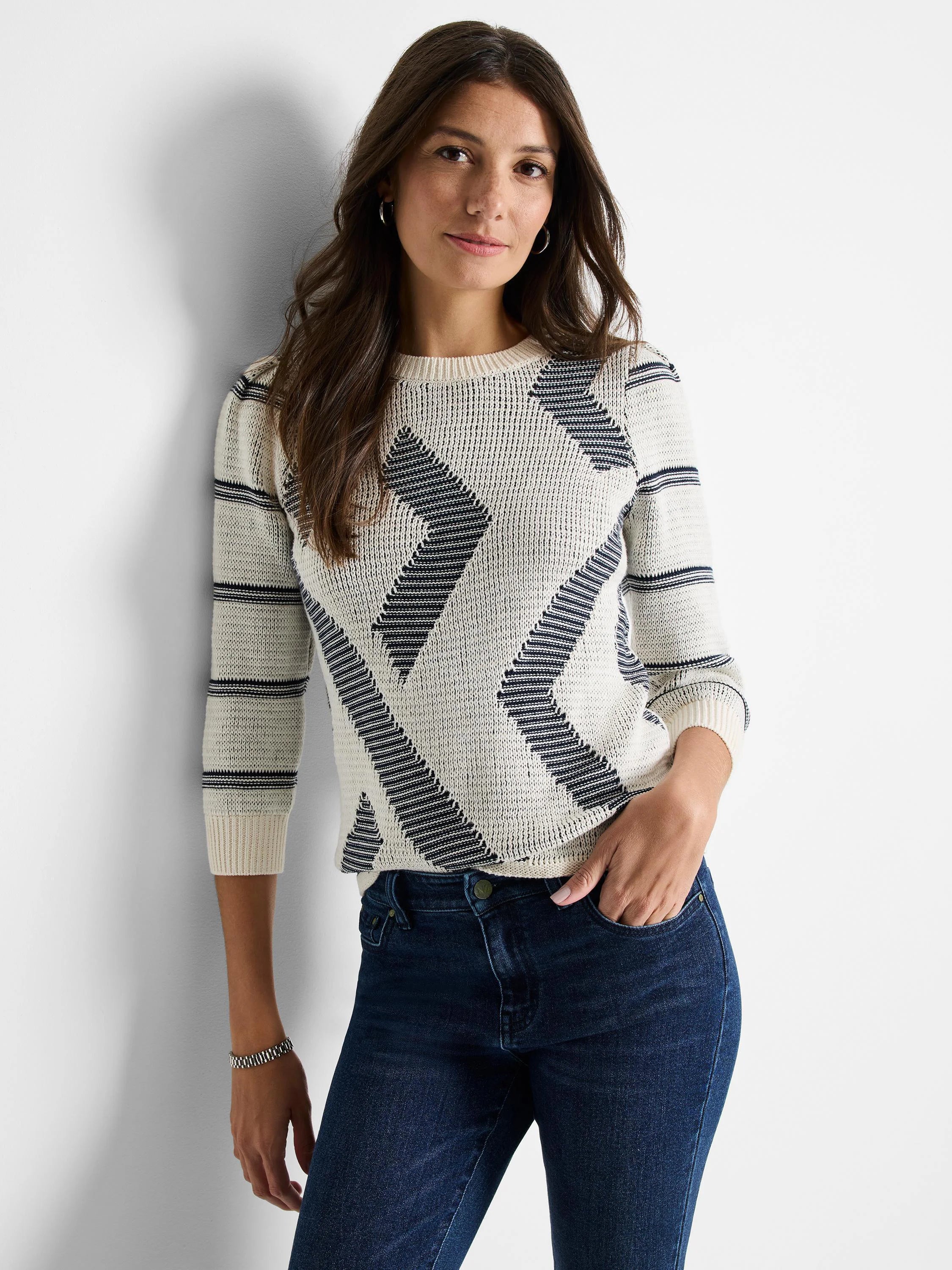 Cream-colored sweater with dark gray/navy diagonal stripes and pattern. Three-quarter sleeves, crew neck.