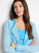 Light blue mix knit jacket with fringe along the front opening and cuffs. Silver snaps detail the cuffs.