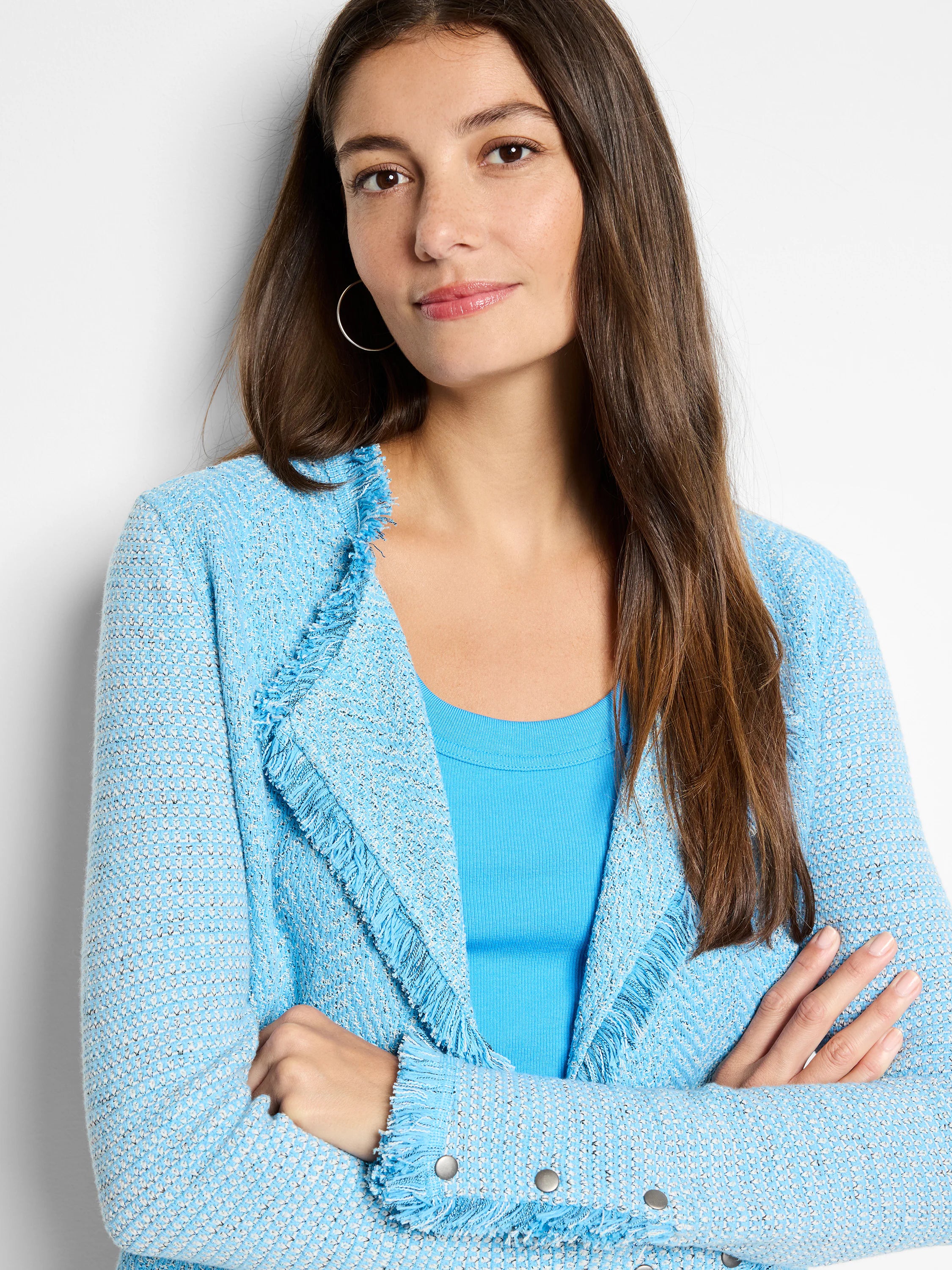 Light blue mix knit jacket with fringe along the front opening and cuffs. Silver snaps detail the cuffs.