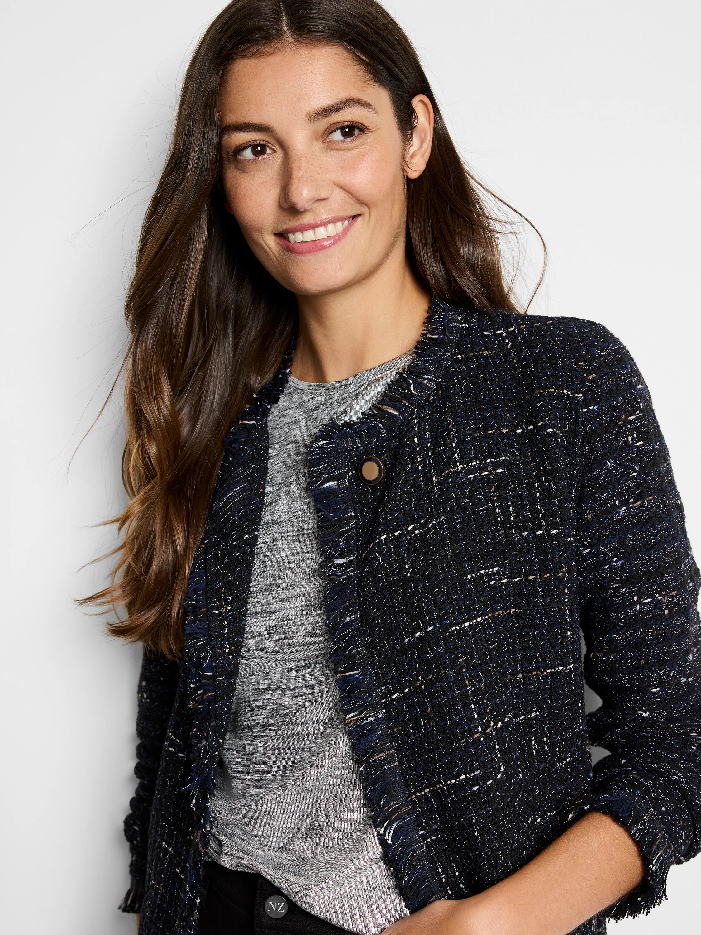Navy blue tweed jacket with beige and white flecks. Fringe trim at neckline and sleeves. Single button closure.