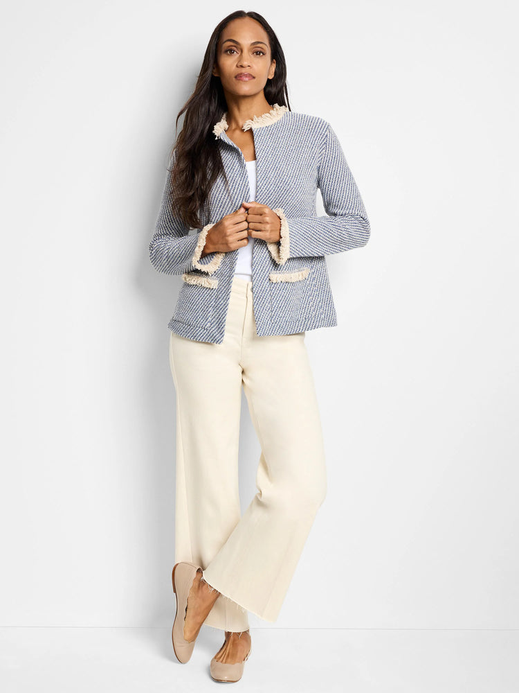 Blue and white tweed jacket with beige fringe trim; open front.