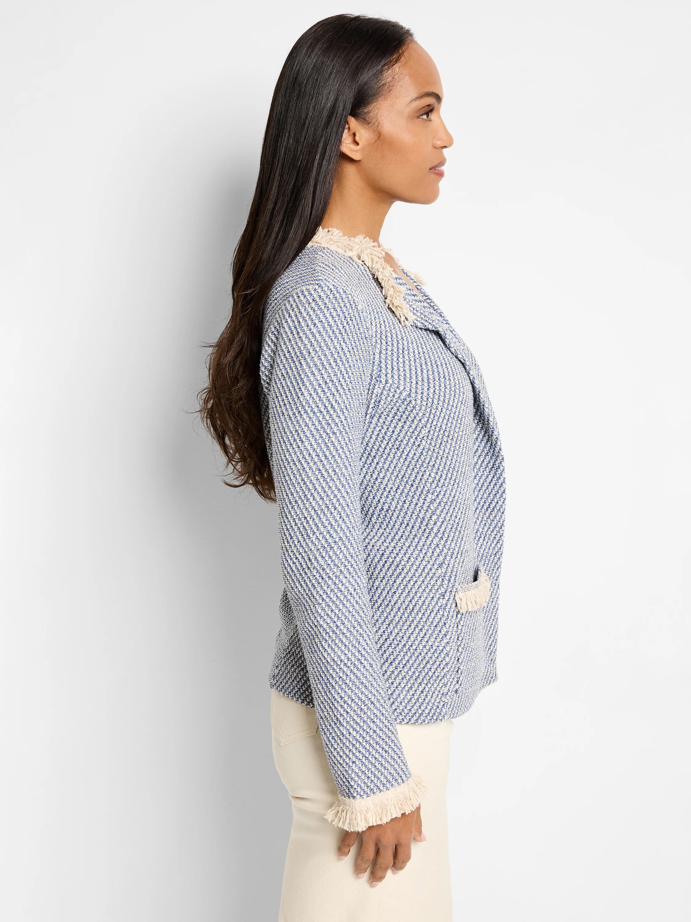 Blue and cream textured tweed jacket. Off-white fringe trim at collar and cuffs. Side profile view.