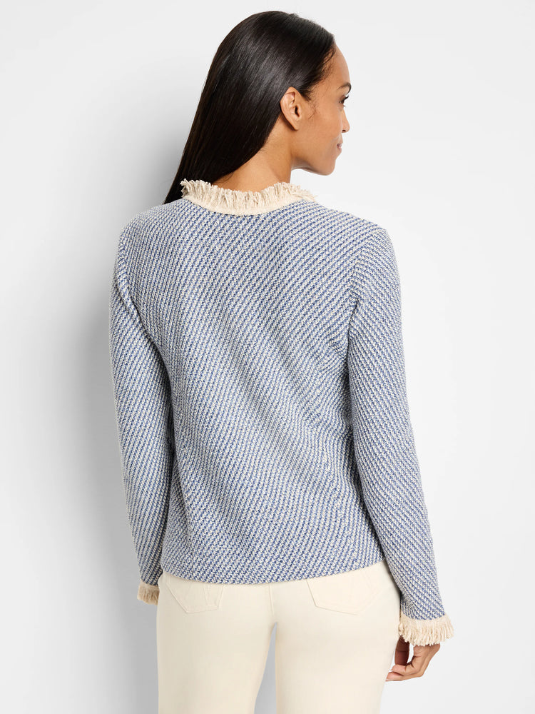 Blue and cream tweed jacket with fringe trim at neckline and sleeves. Back view.