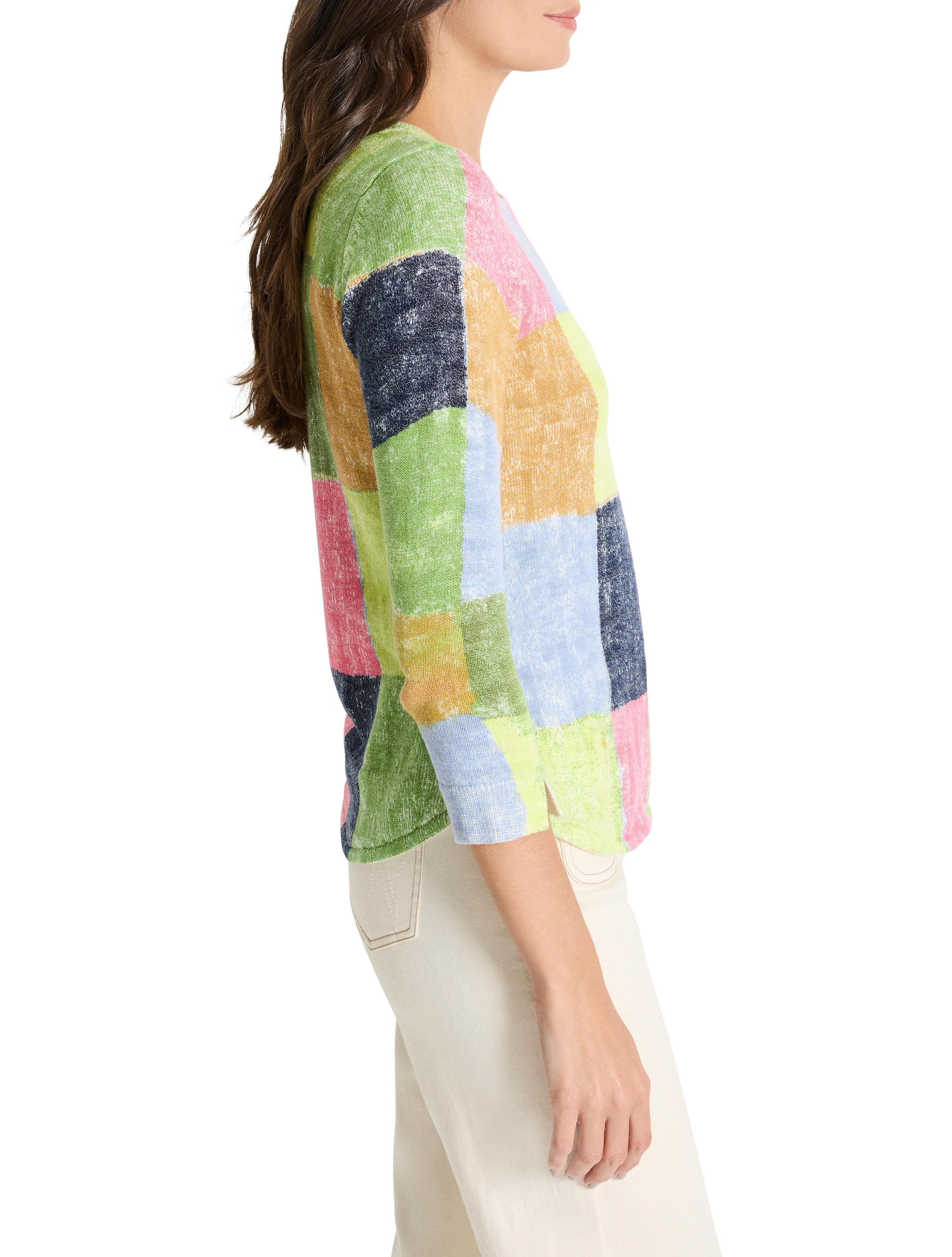 Multicolored, patchwork-style sweater. Includes light green, pink, light blue, and tan squares. Three-quarter sleeves.