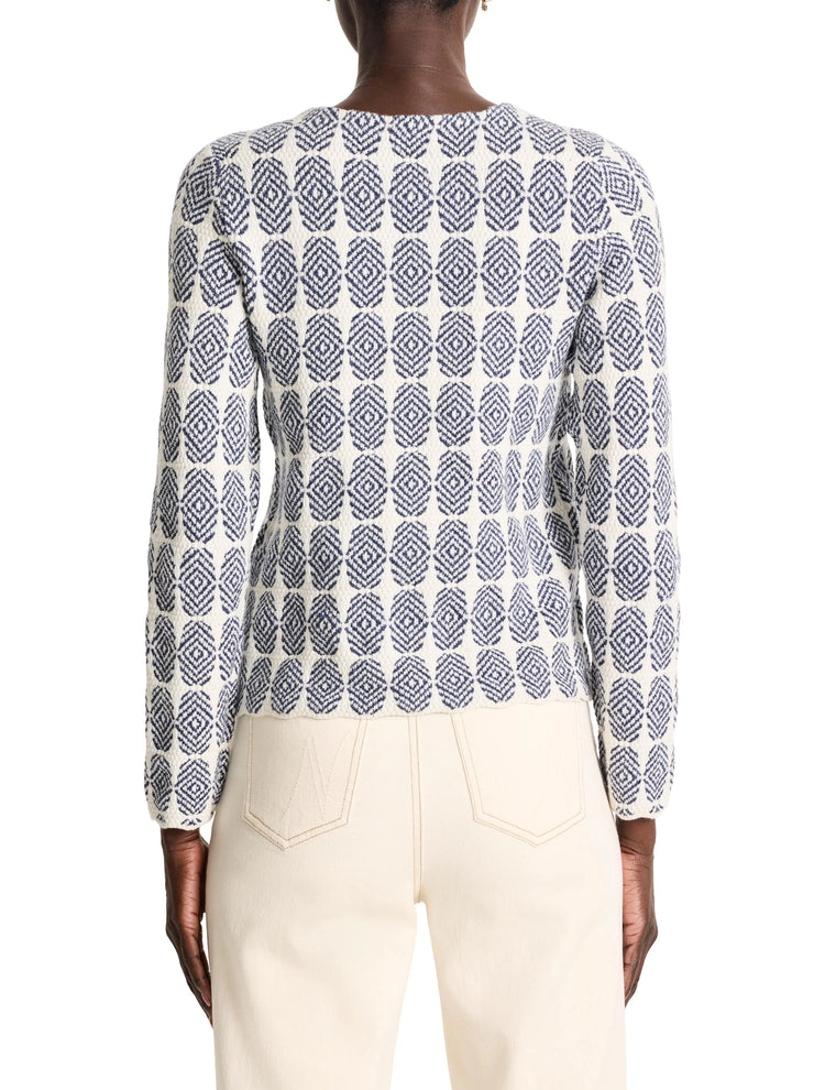 Cream-colored knit jacket with a dark-blue geometric pattern. Long sleeves.