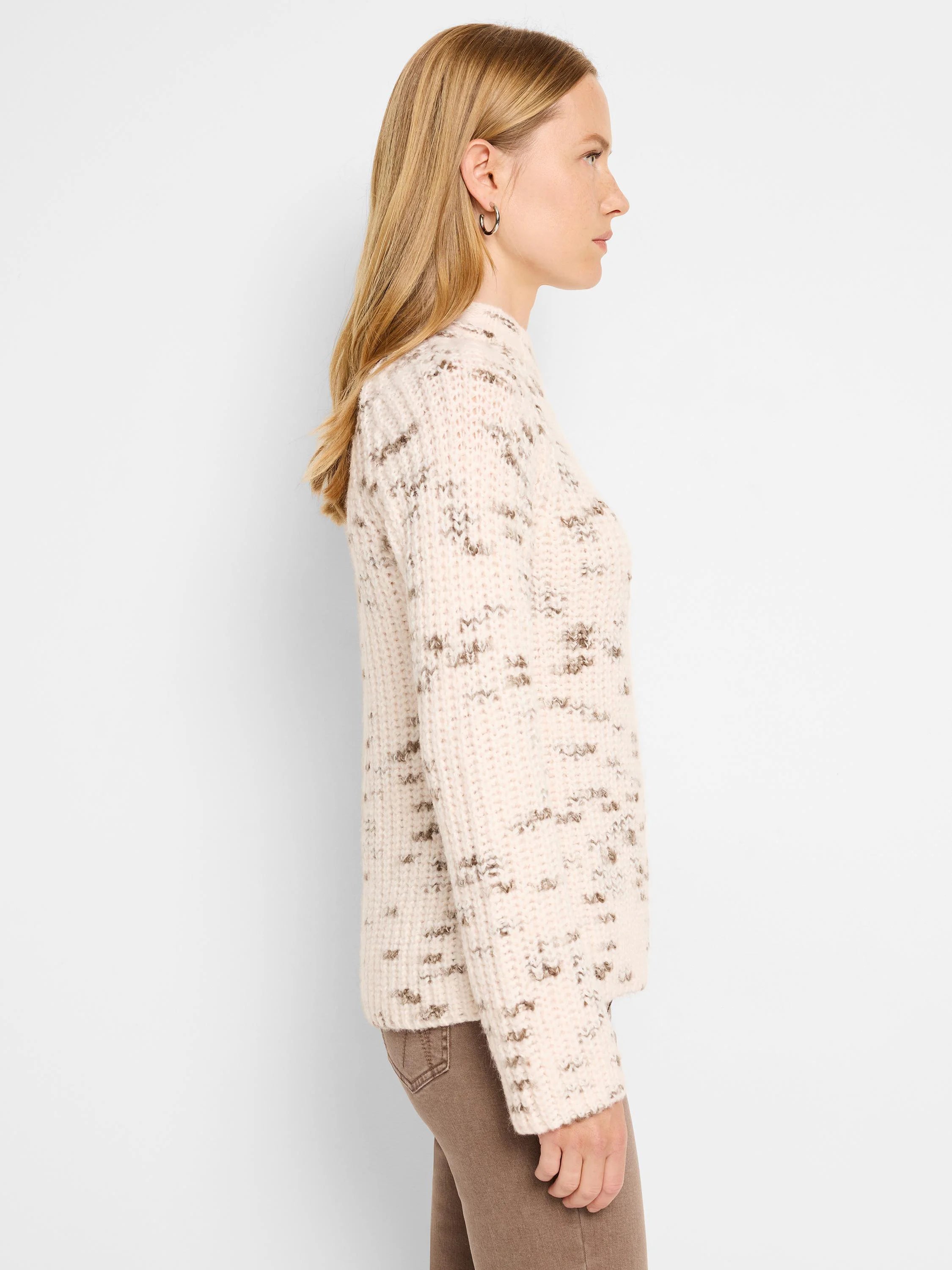 Off-white sweater with brown flecks, long sleeves, and a mock neck.