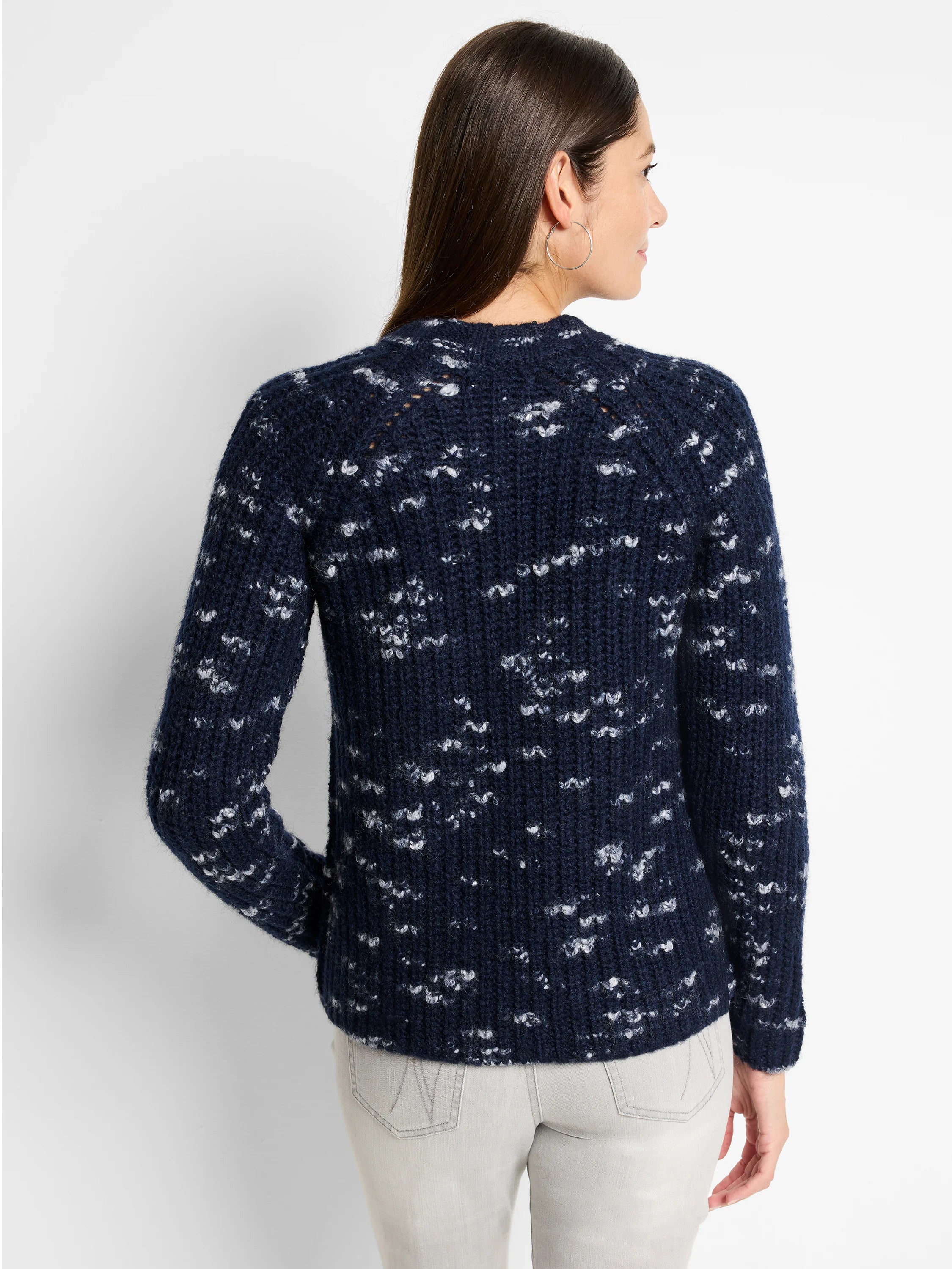 Navy blue sweater with a speckled white pattern, long sleeves, and a round neckline.