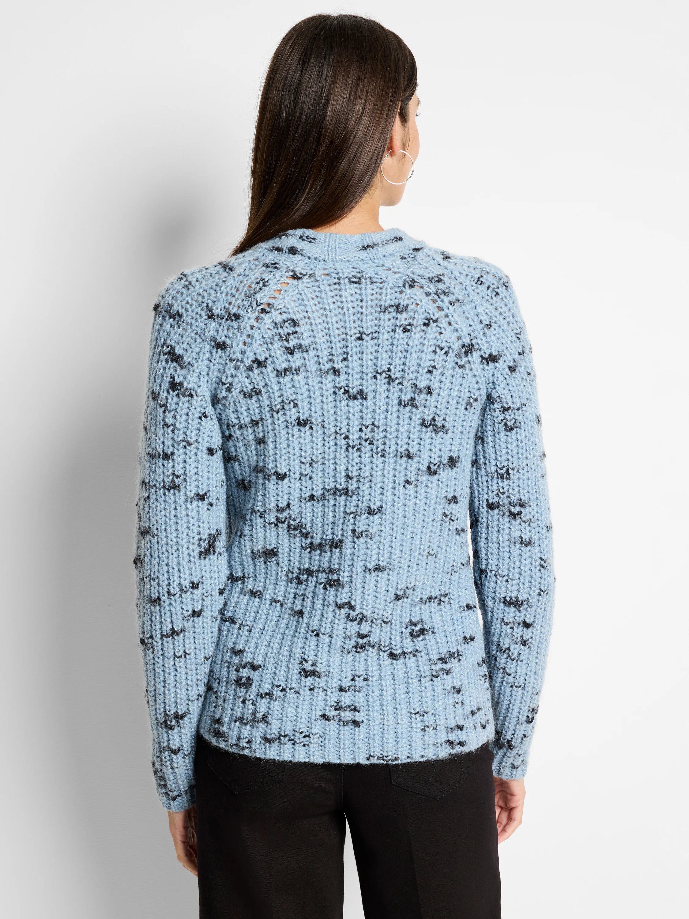 Light blue knit sweater with dark gray flecks; ribbed texture.