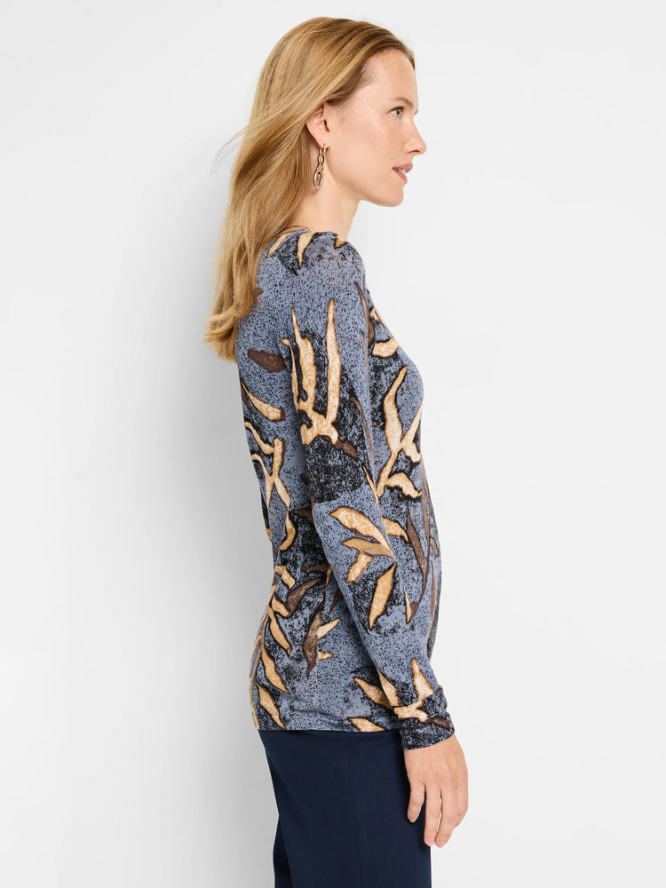 Here's alt text for the image, under 125 characters:
"Blue long-sleeved sweater with tan and brown leaf pattern. Side view.