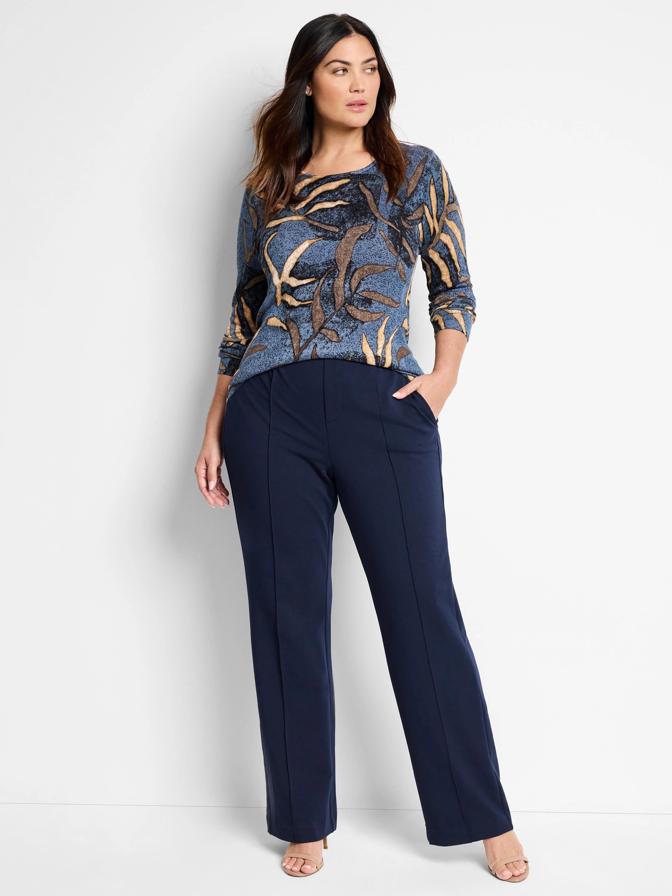 Blue sweater with brown and beige leaf pattern. Long sleeves.