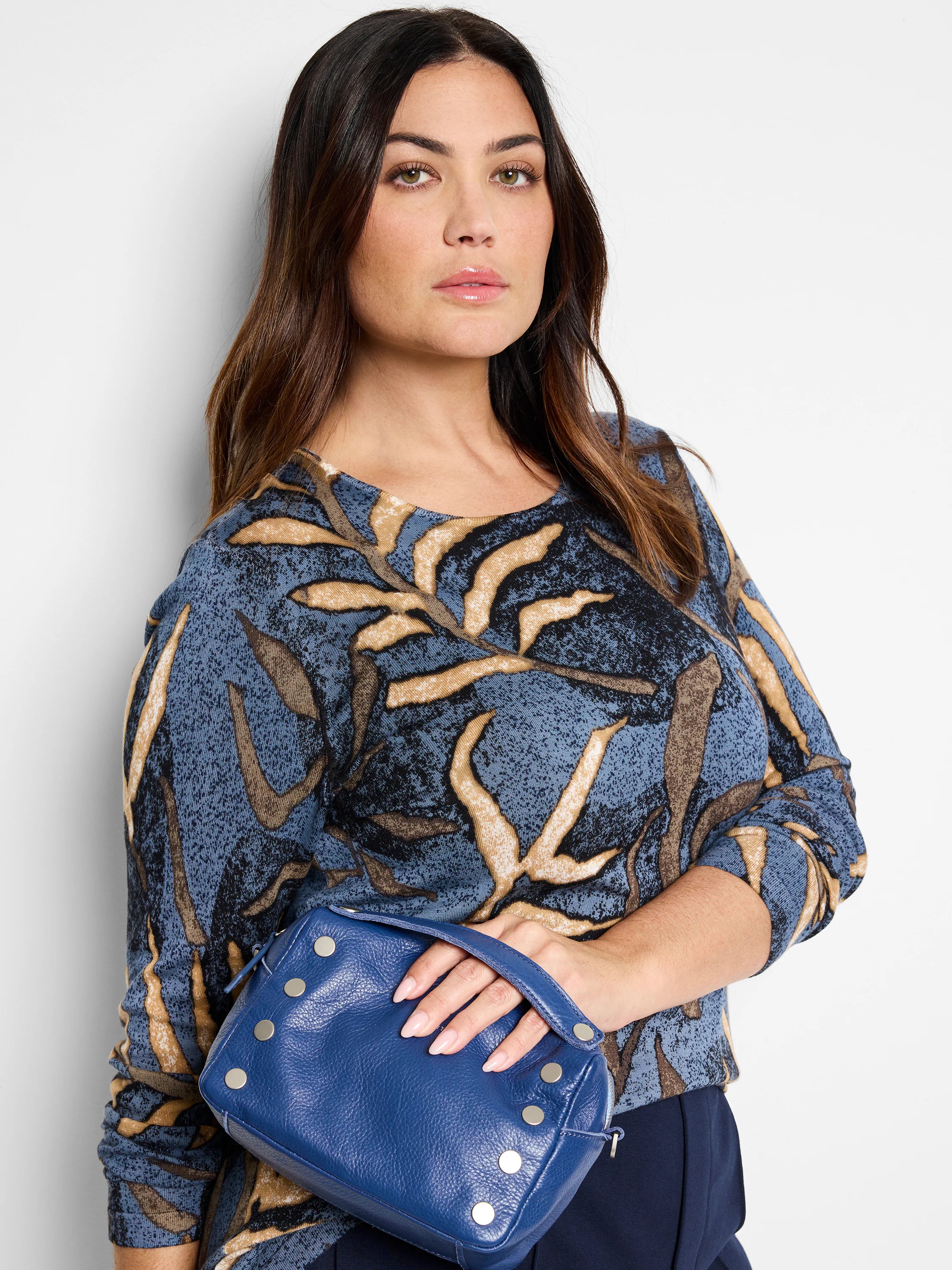 Blue sweater with tan and dark brown leaf pattern.