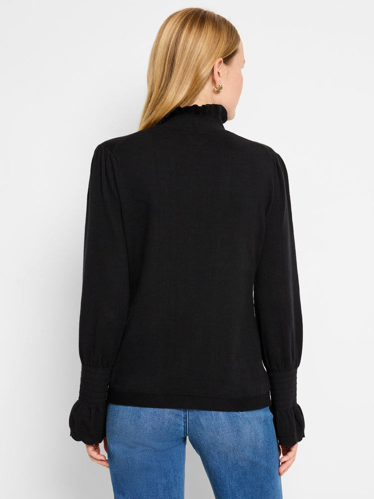 Black mock-neck sweater, long sleeves with ruffled cuffs, and slightly puffed shoulders.