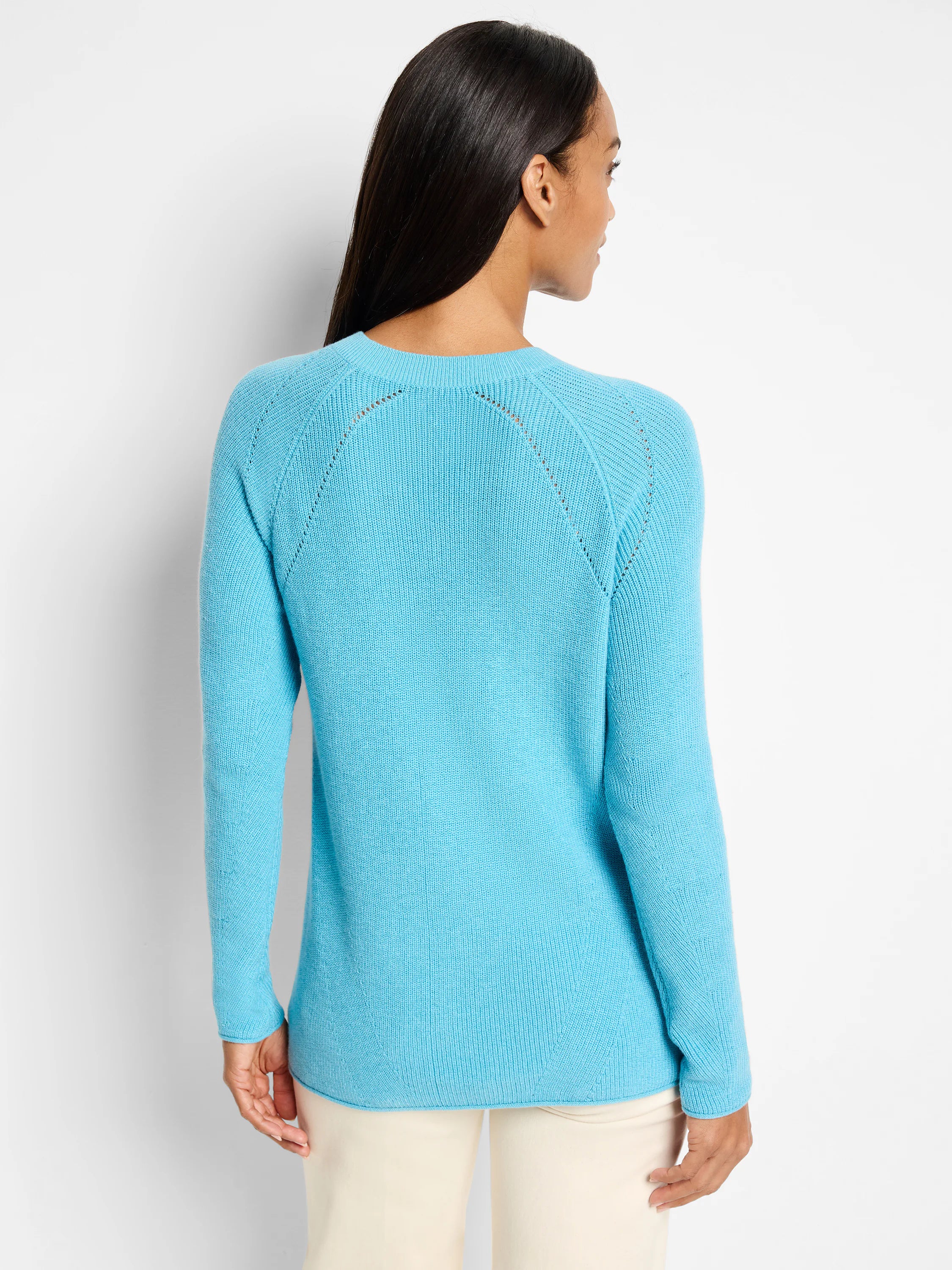 Light blue, V-neck cashmere sweater. Long sleeves, ribbed knit, subtle shoulder detailing.