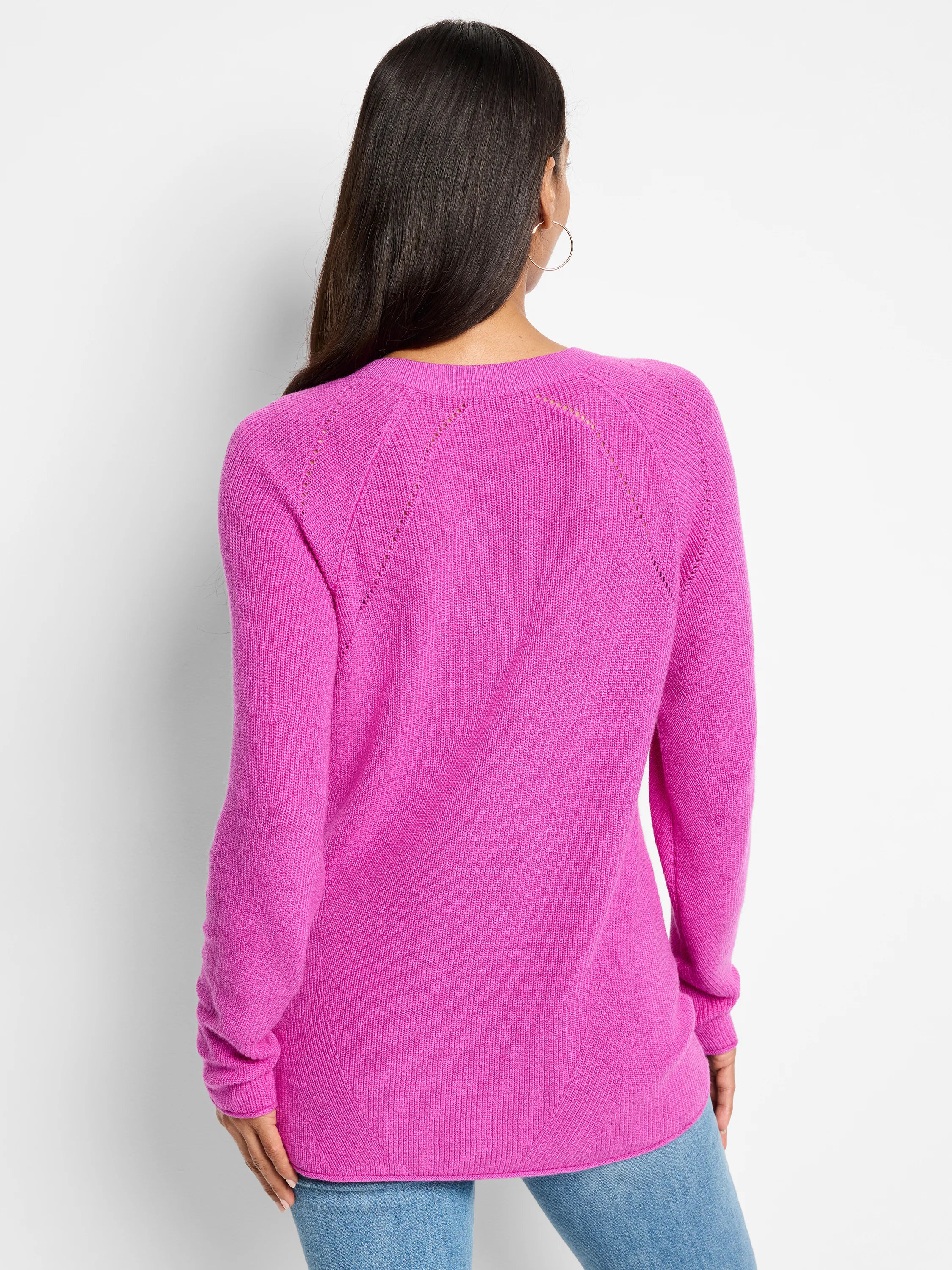 Fuchsia V-neck sweater, long sleeves, ribbed knit texture with eyelet detailing at shoulders.