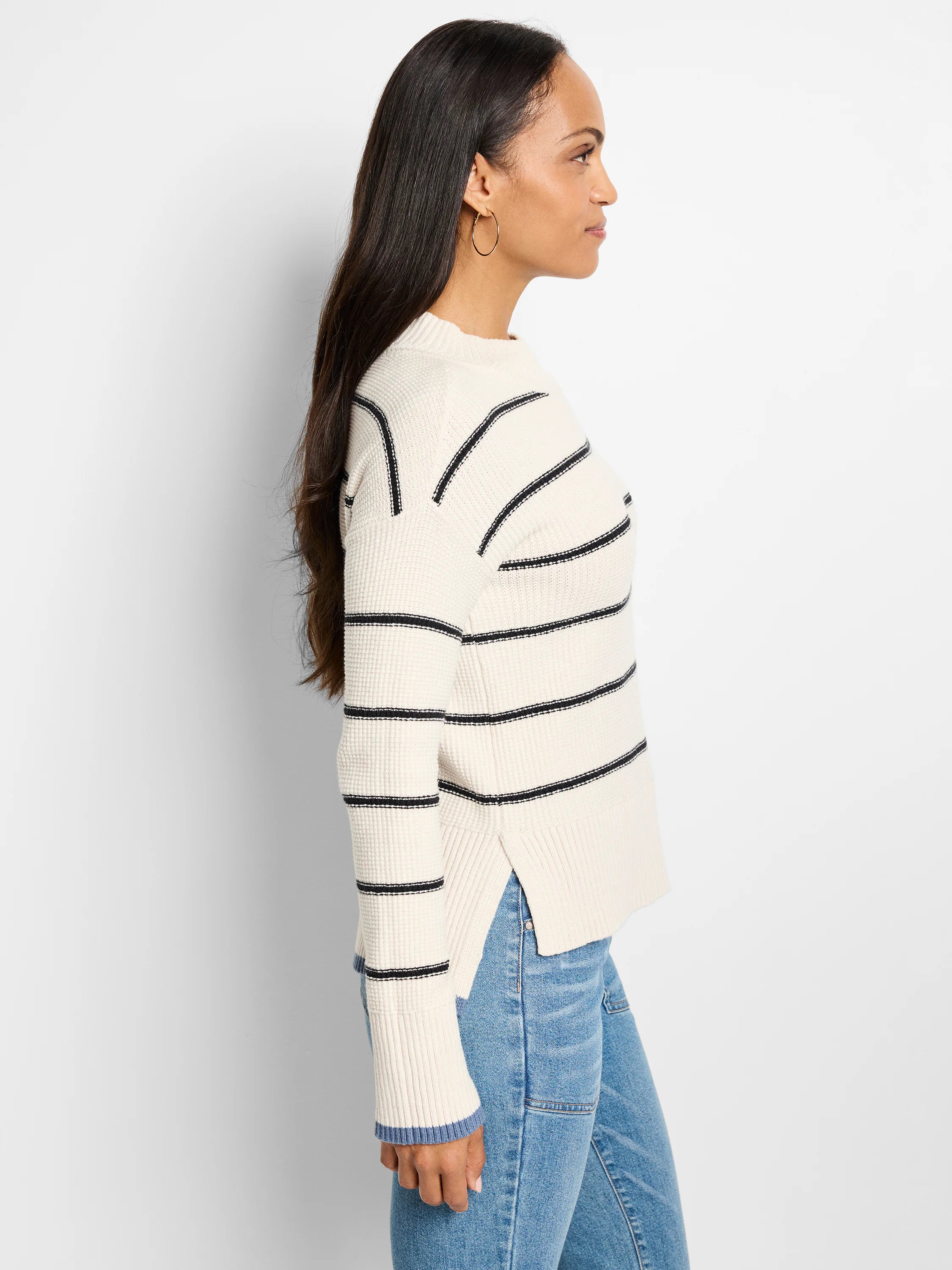 Cream waffle-knit sweater with thin dark-navy stripes; cuffs have a light-blue interior detail.