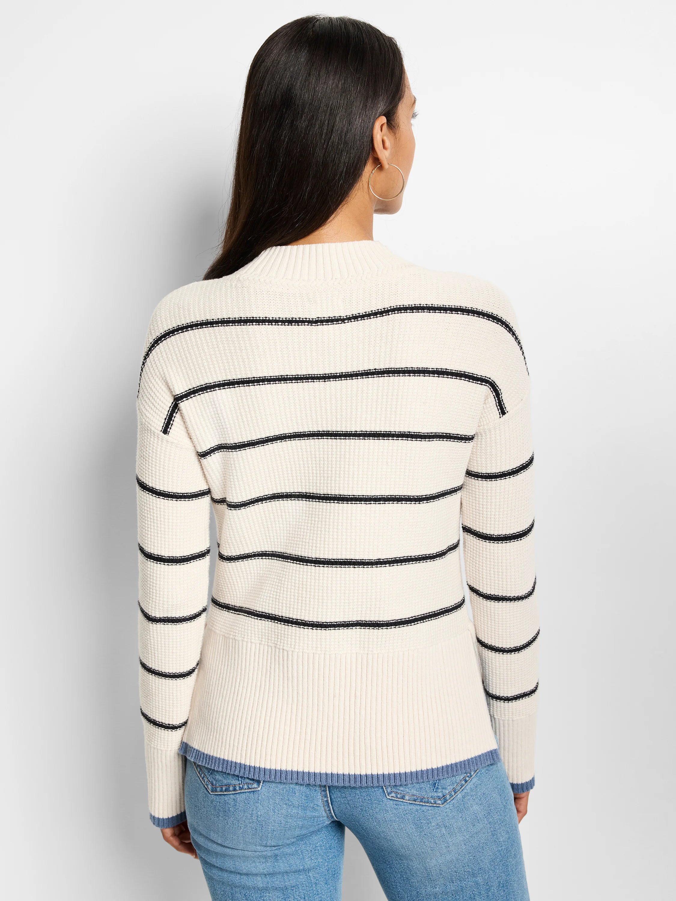 Cream waffle-knit sweater with thin black stripes. Bottom hem and cuffs have a light blue trim.